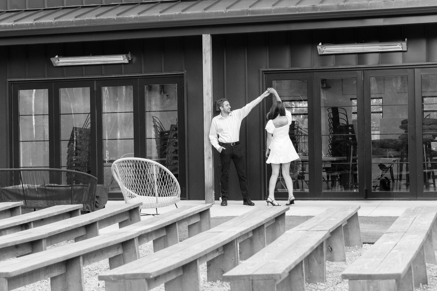 Moody and romantic couples photo with the Pinewood venue softly blurred in the background, highlighting emotion and connection.