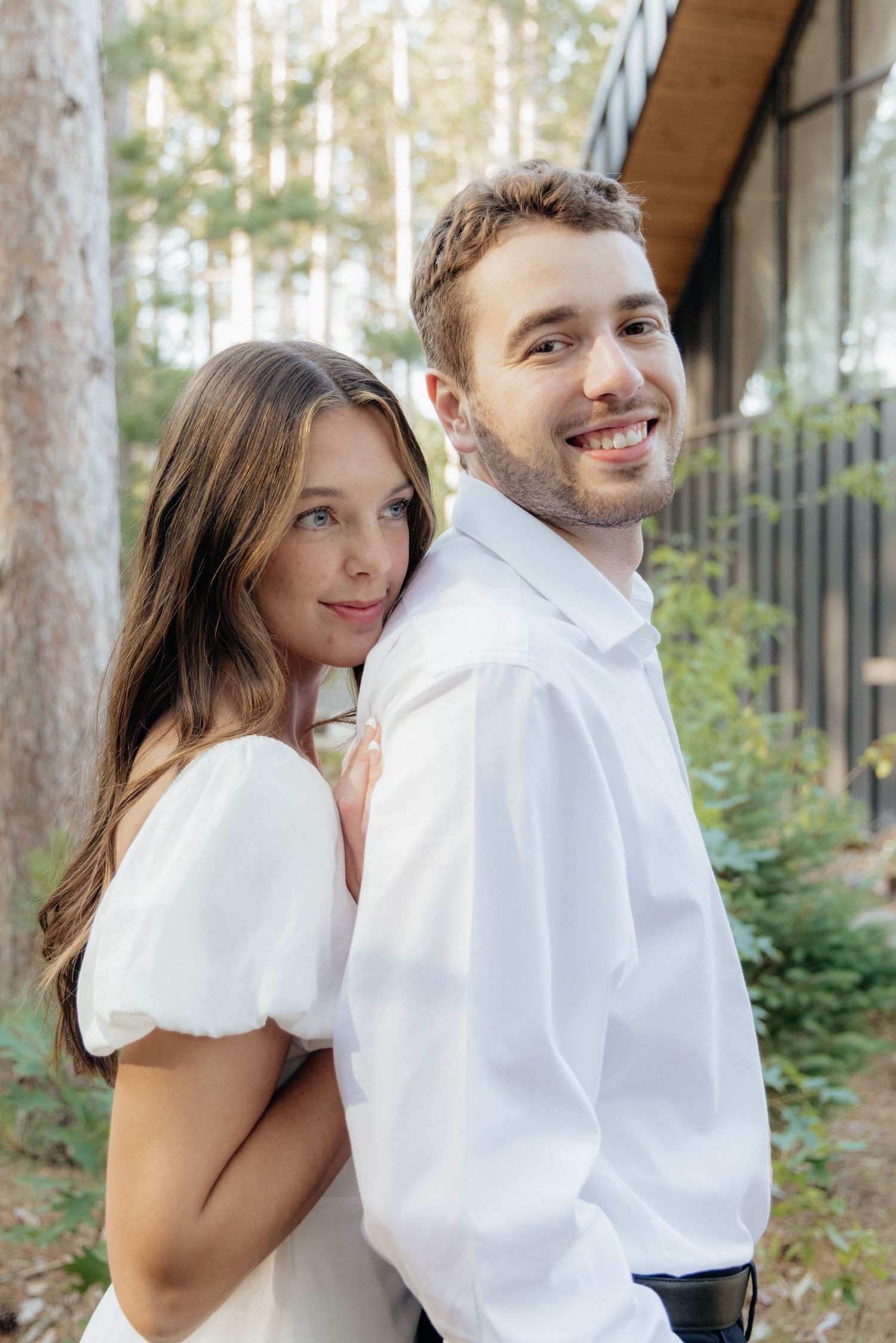 Moody and romantic couples photo with the Pinewood venue softly blurred in the background, highlighting emotion and connection.