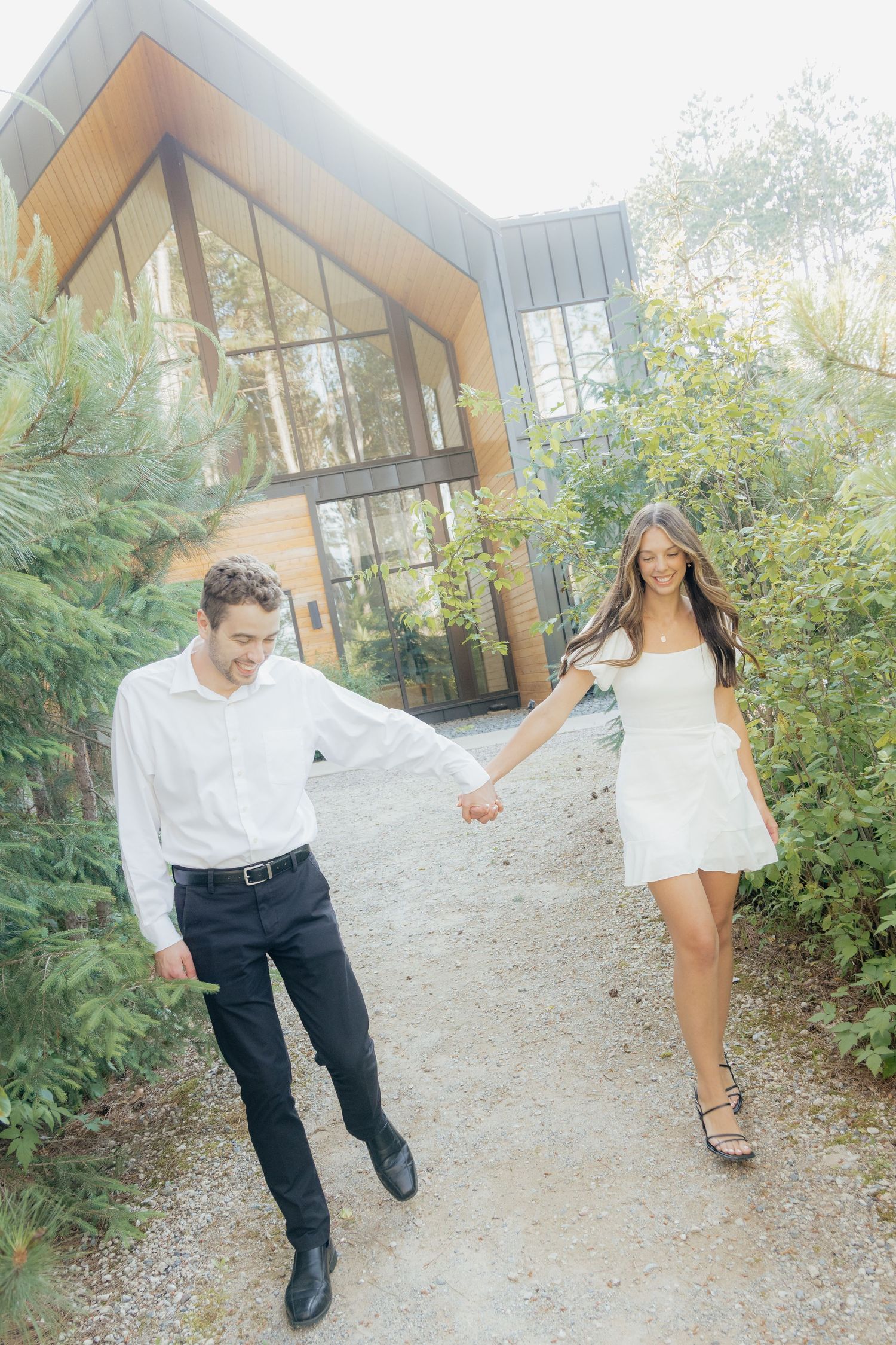 Moody and romantic couples photo with the Pinewood venue softly blurred in the background, highlighting emotion and connection.