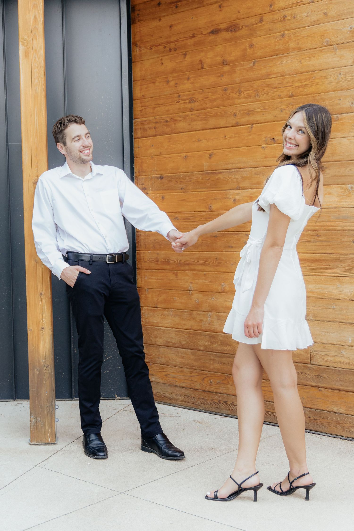 Moody and romantic couples photo with the Pinewood venue softly blurred in the background, highlighting emotion and connection.
