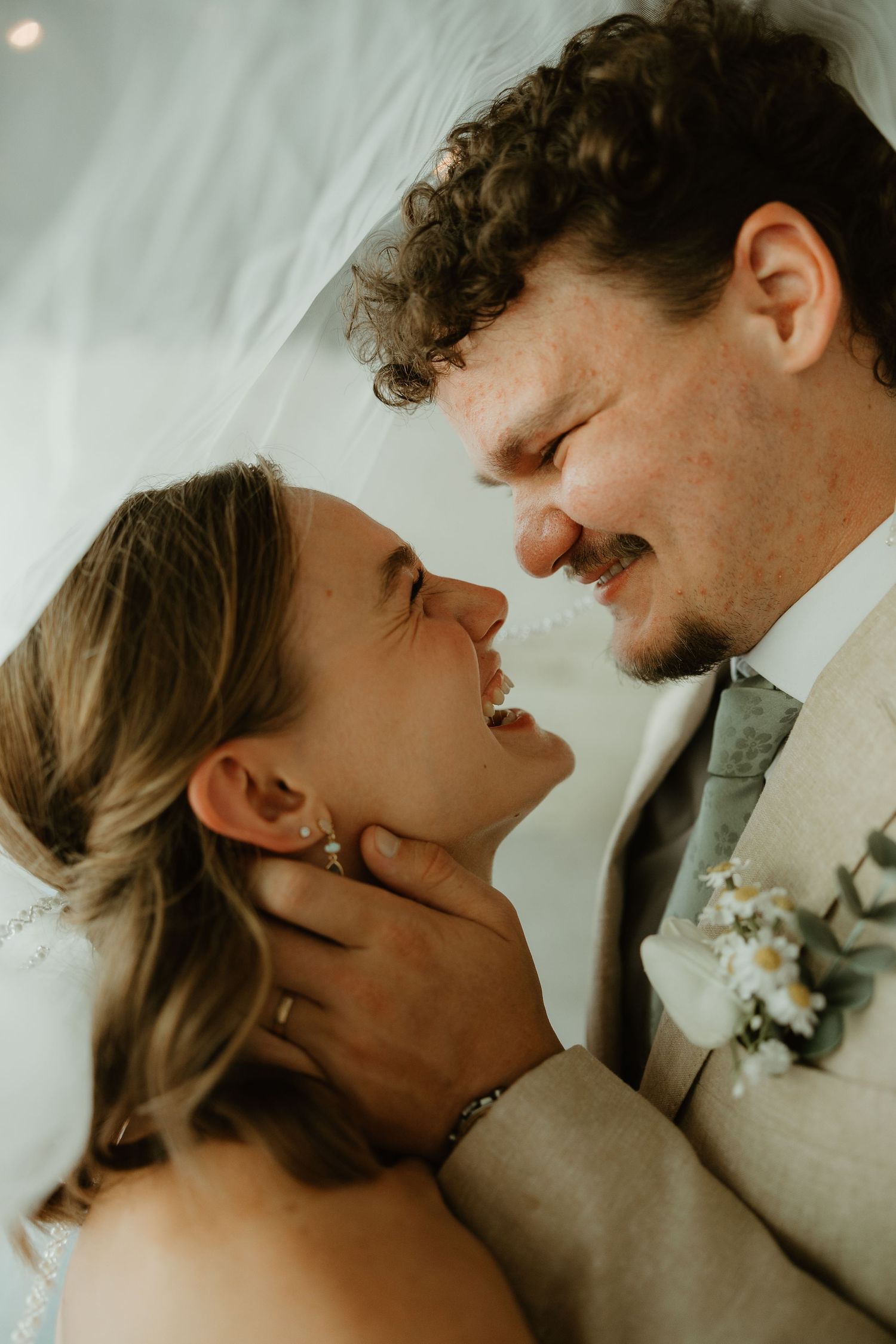 A romantic wedding couple share an intimate kiss sequence captured in soft light.