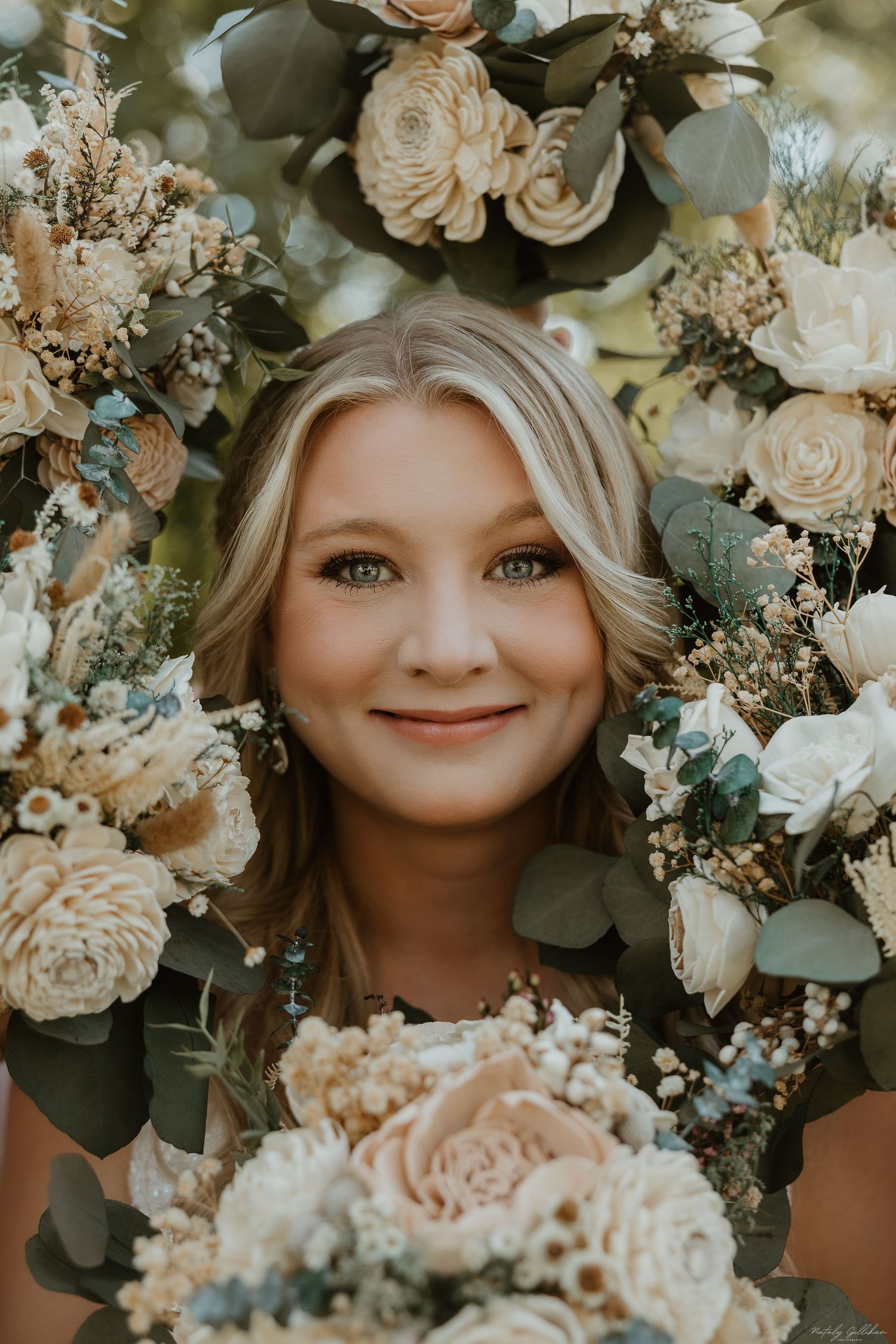 Soft peach roses and eucalyptus create a romantic floral arrangement with warm muted tones and natural greenery.