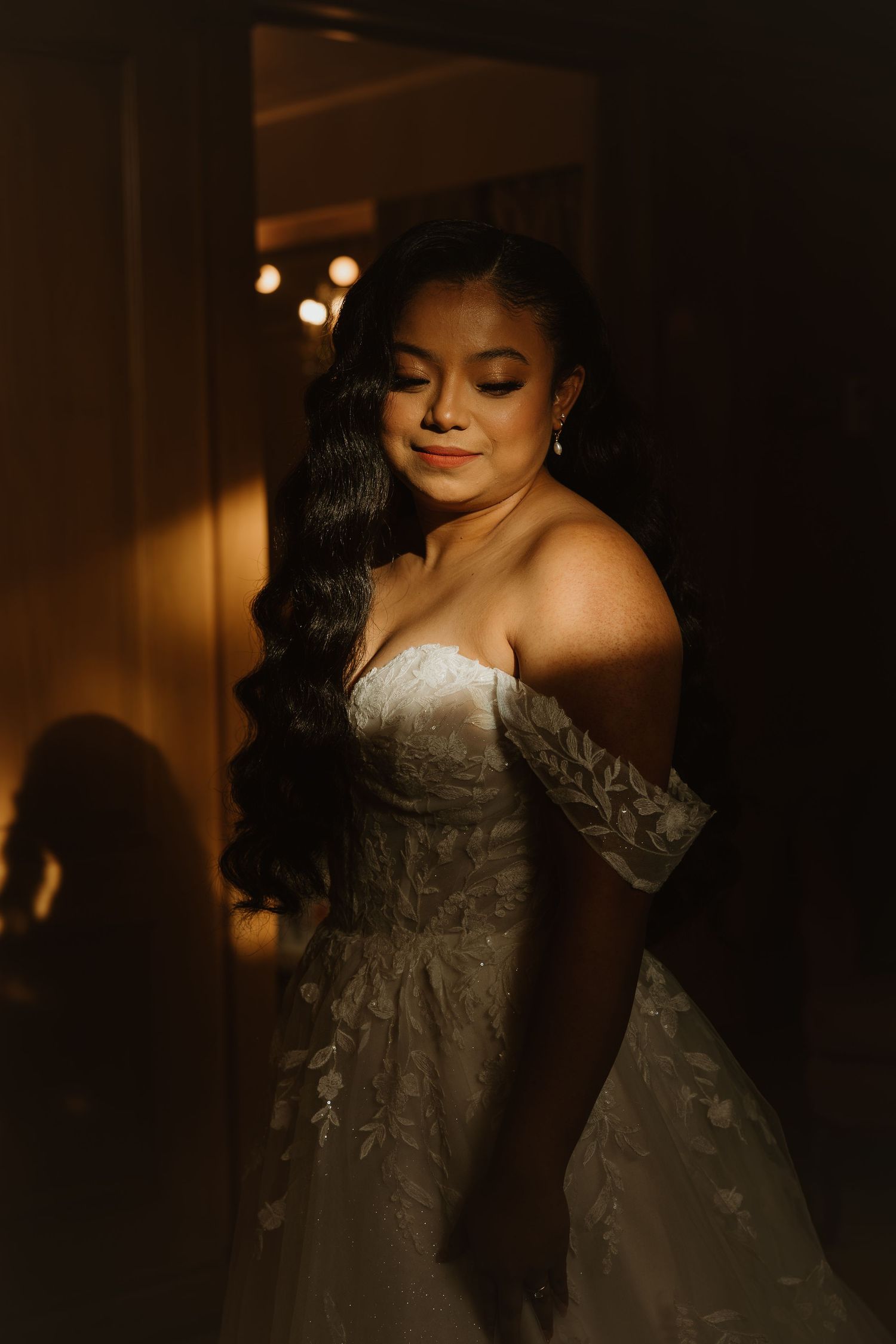 Artistic bridal portraits in moody lighting showcase intricate lace details and elegant styling.