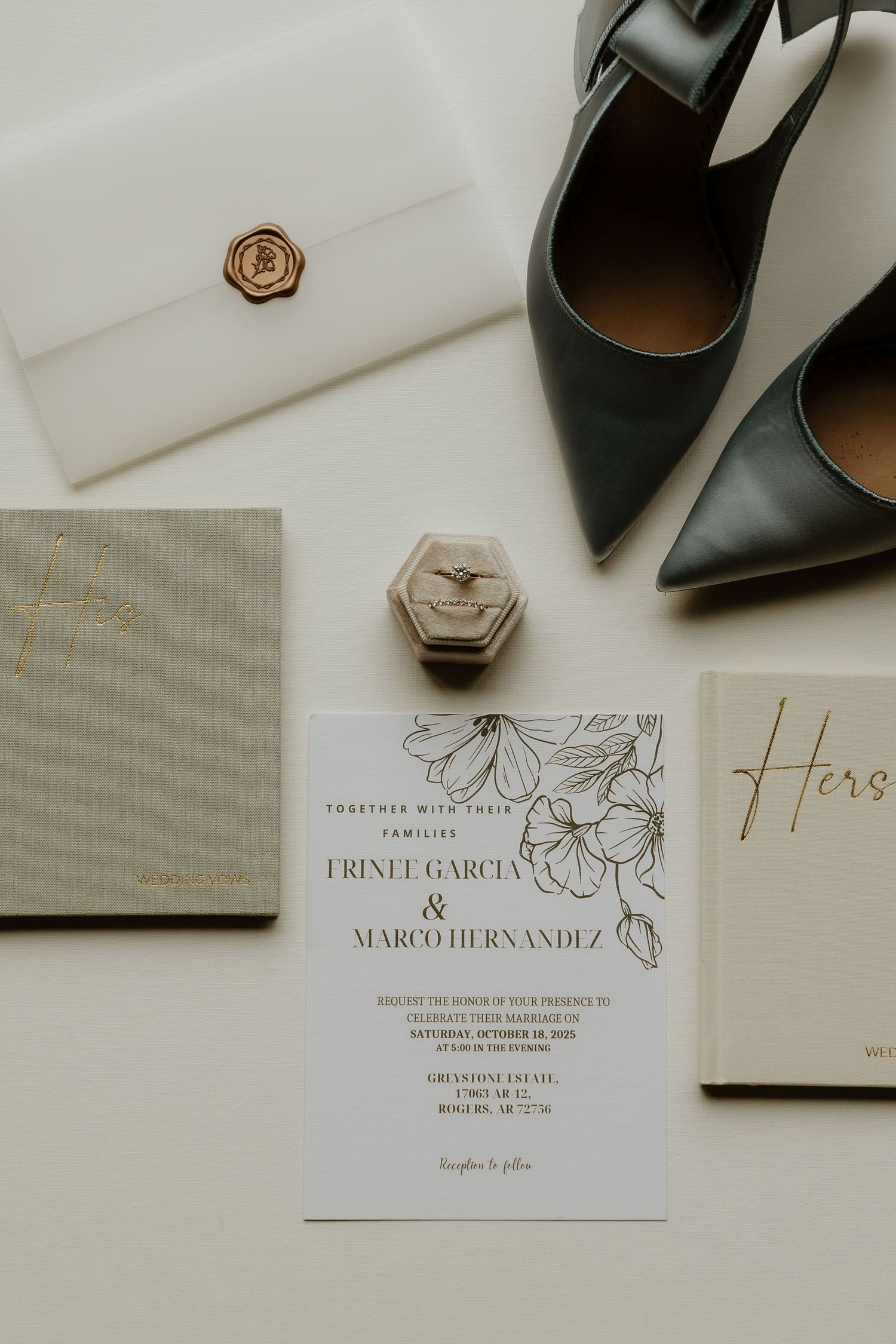 Elegant wedding invitation cards with floral designs and black heels displayed on a light neutral background.