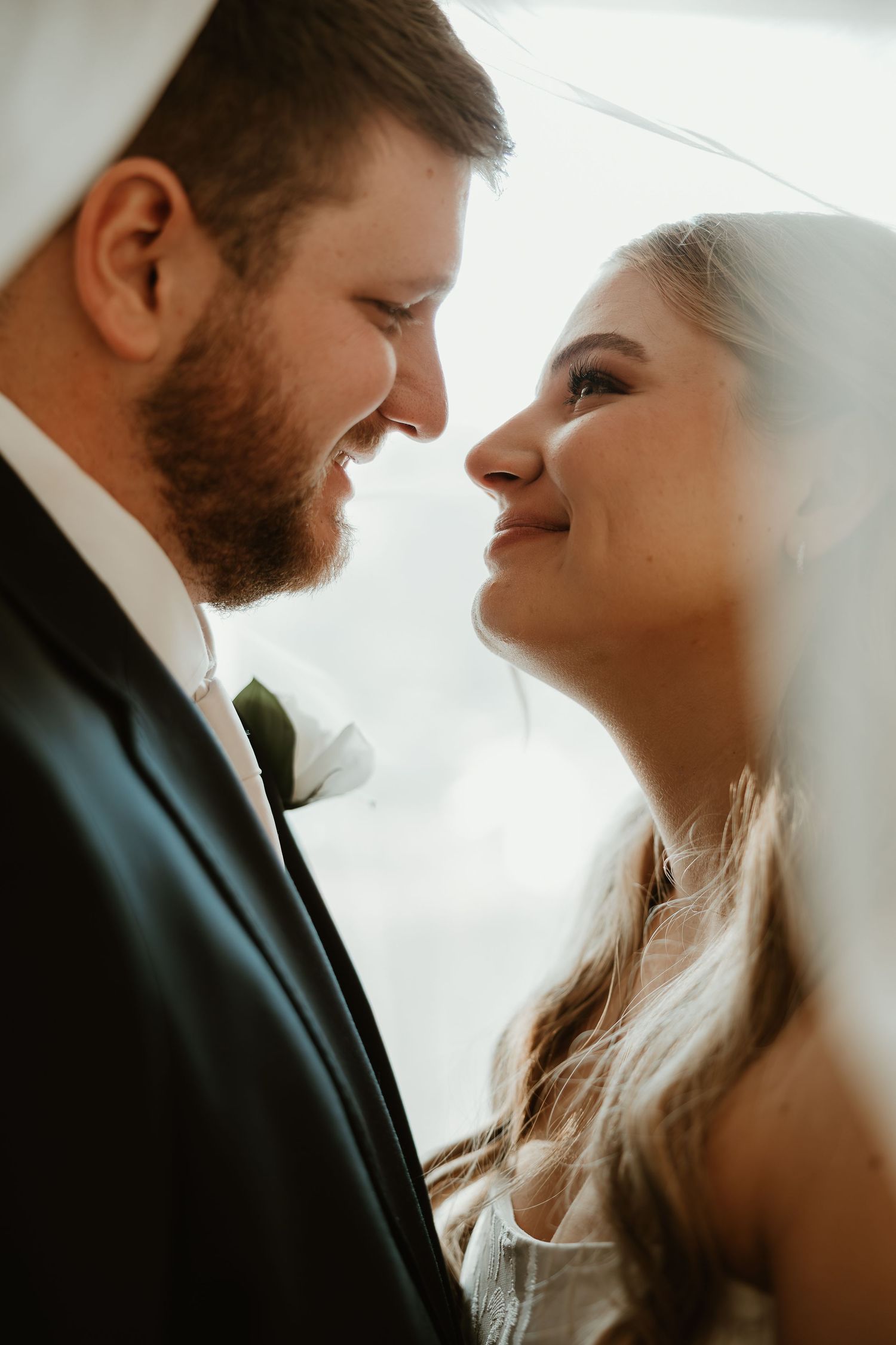 A romantic wedding couple shares intimate close-up moments in a series of soft, dreamy portraits.