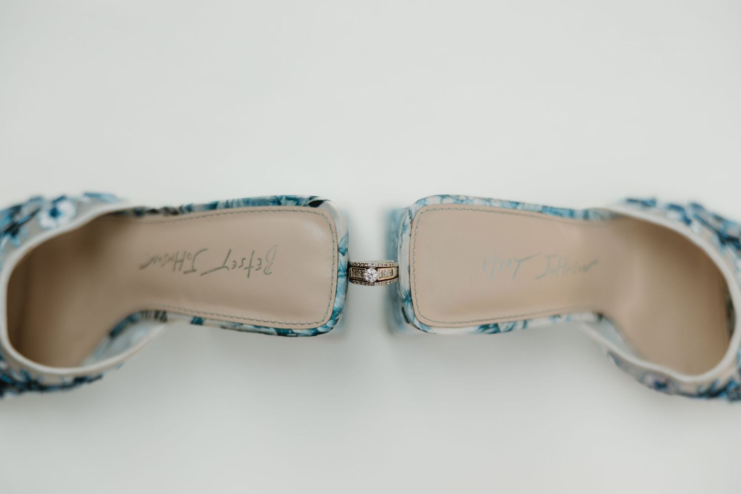 Close-up view of light blue ballet flats with delicate bow details arranged in a row.
