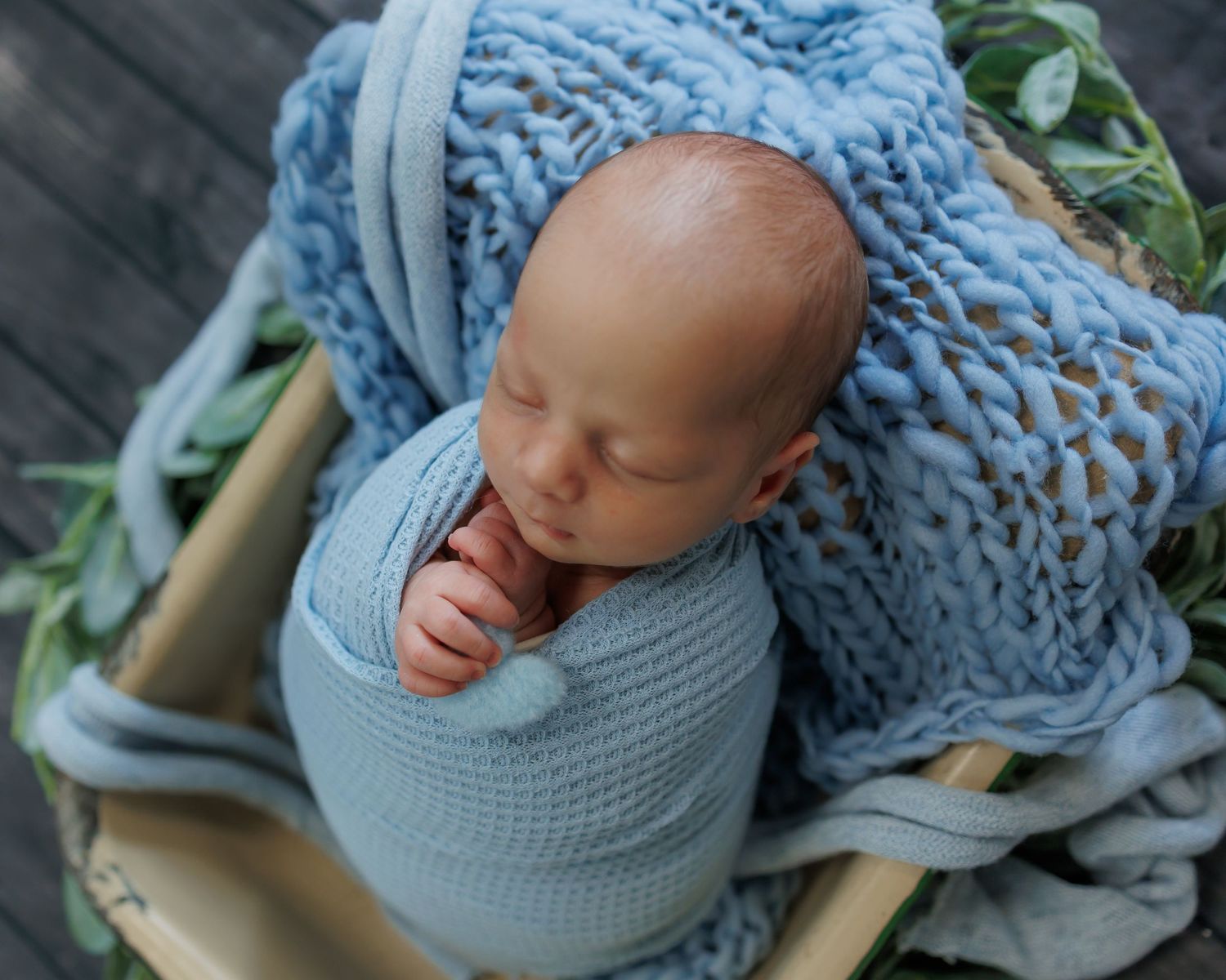 Newborn photography collage showing baby wrapped in soft blue blankets and posed in gentle sleeping positions.