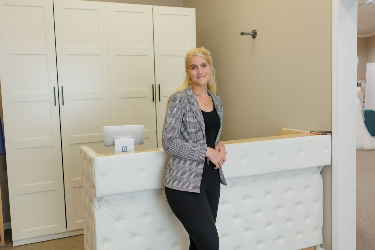 Professional office interior with white tufted headboard and built-in storage cabinets.