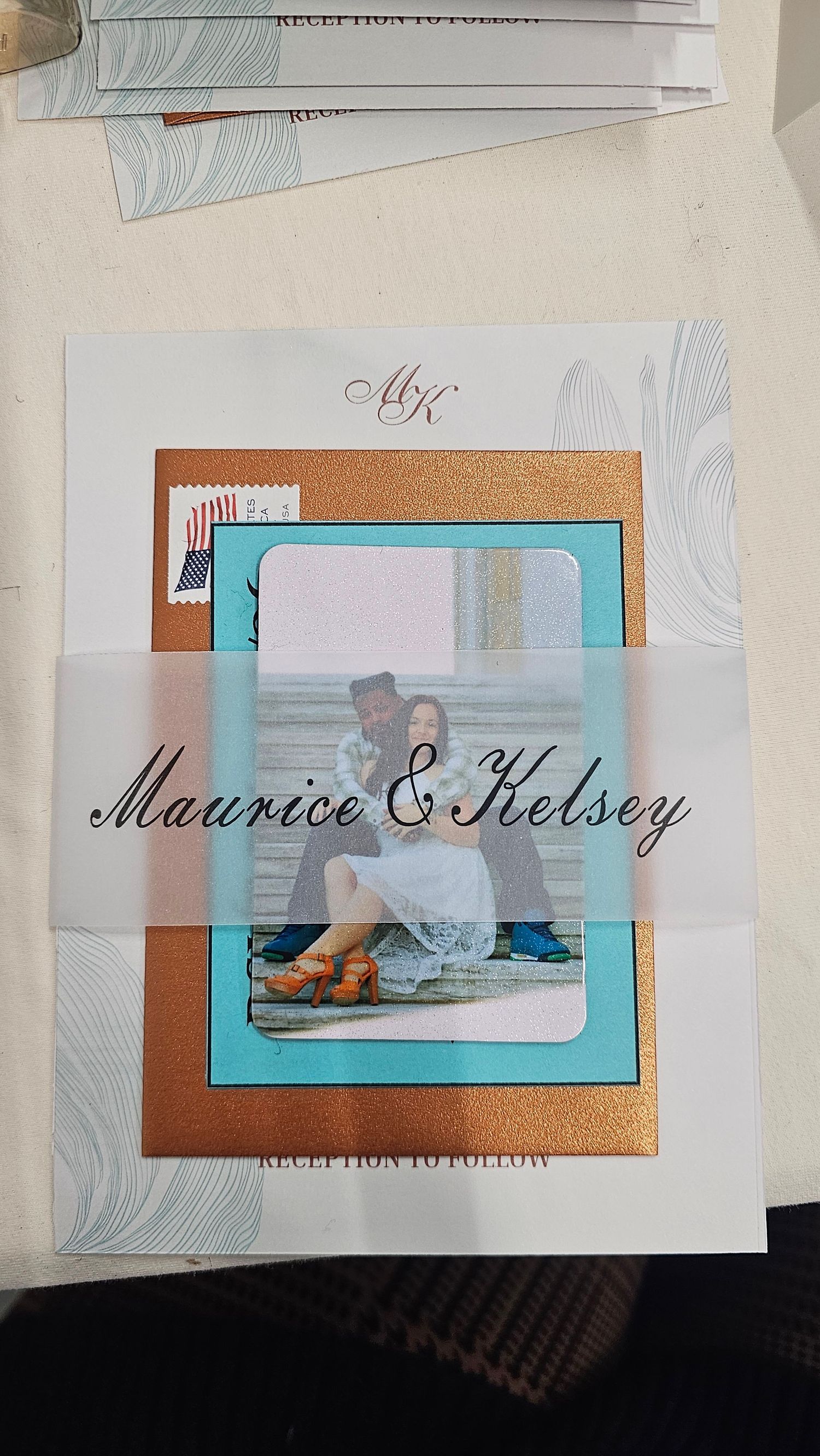 Wedding invitation cards in turquoise and copper colors featuring elegant script text and photo layouts.