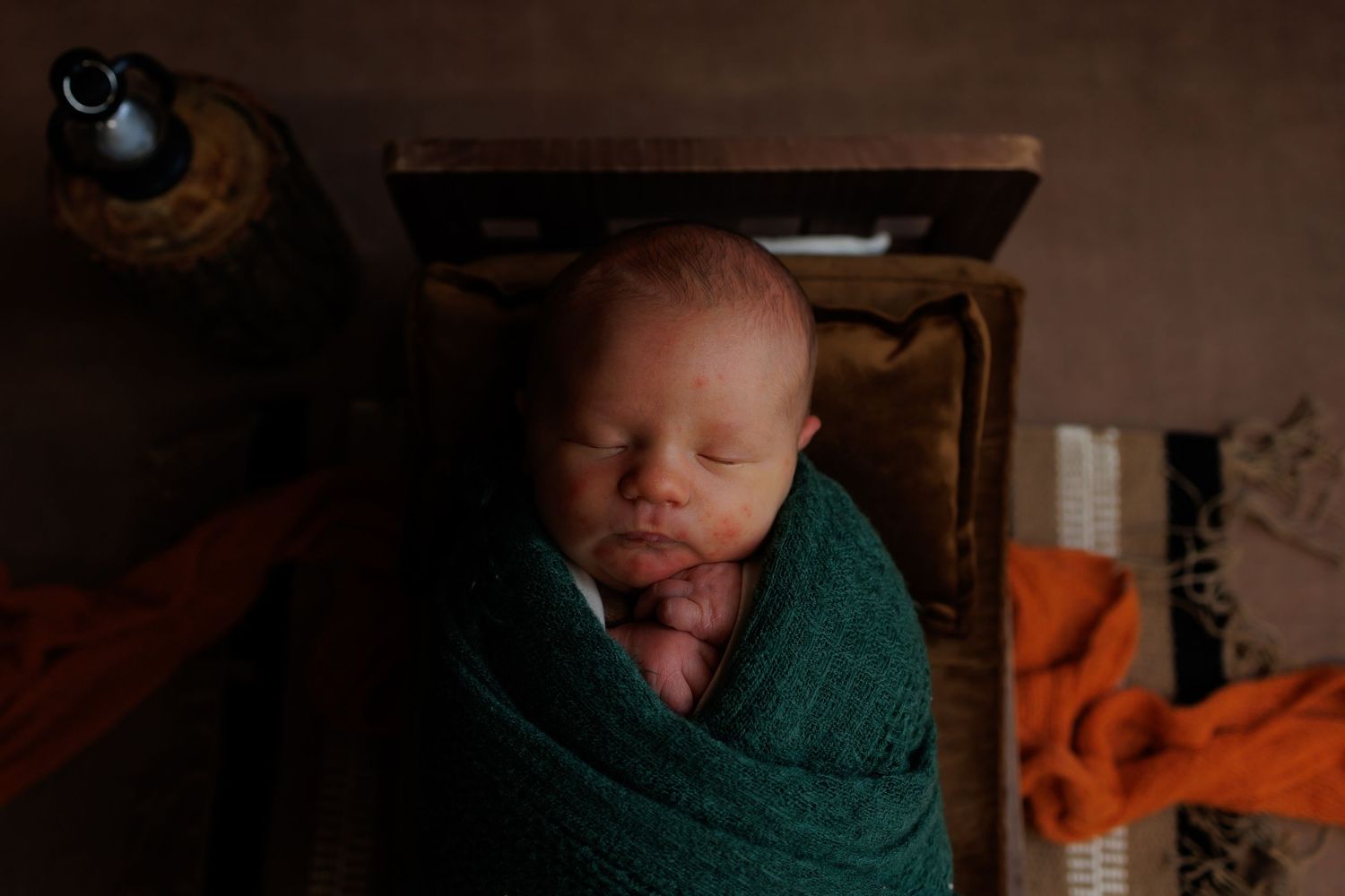 A series of candid baby photos showing various expressions and poses in warm, moody lighting.