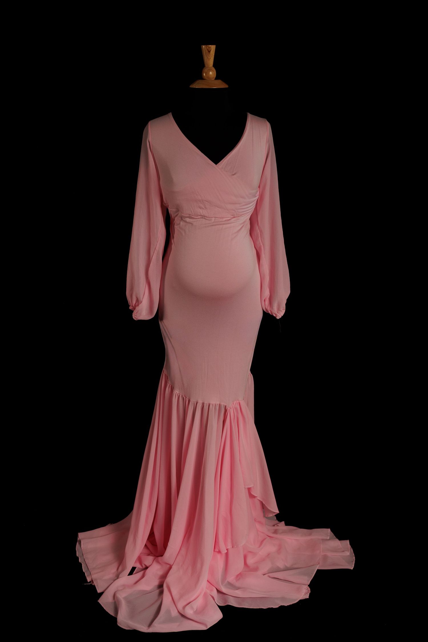 Pink vintage-style dress with long sleeves and flowing skirt shown from multiple angles against black background.