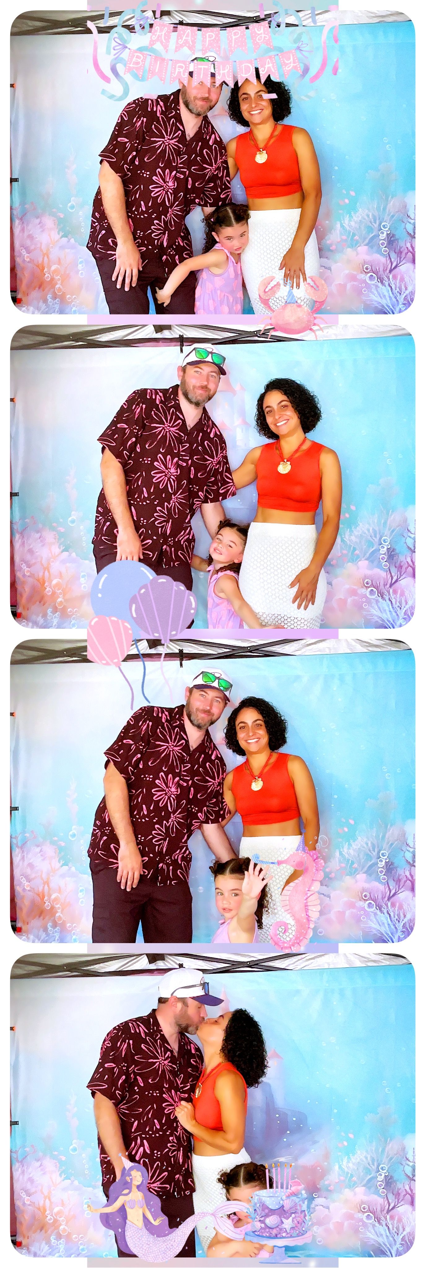 A family poses together in a photo booth with a dreamy underwater-themed backdrop featuring pink and blue colors.