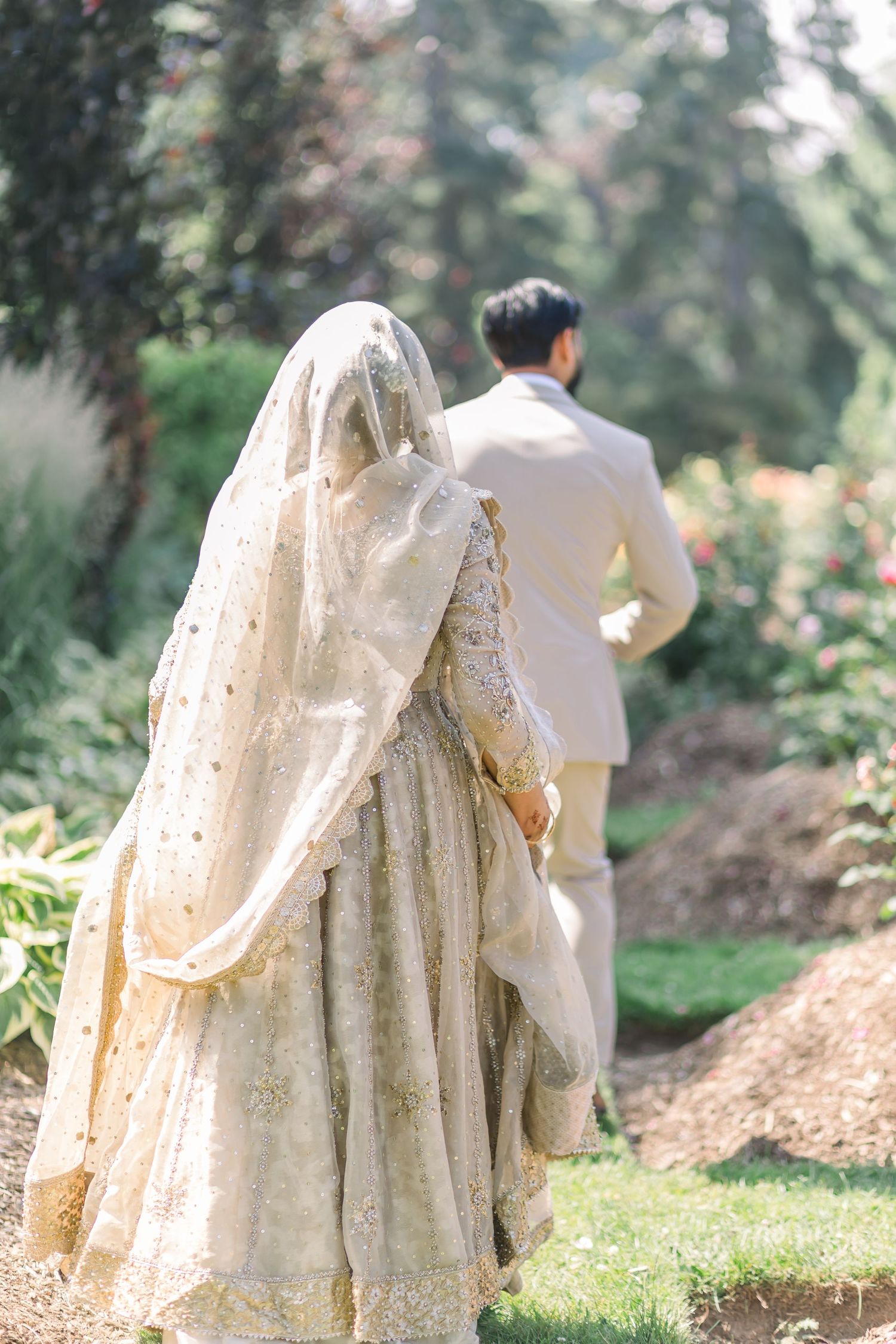 A series of eight connected photos showing a person in a long white dress walking through a sunlit garden setting.