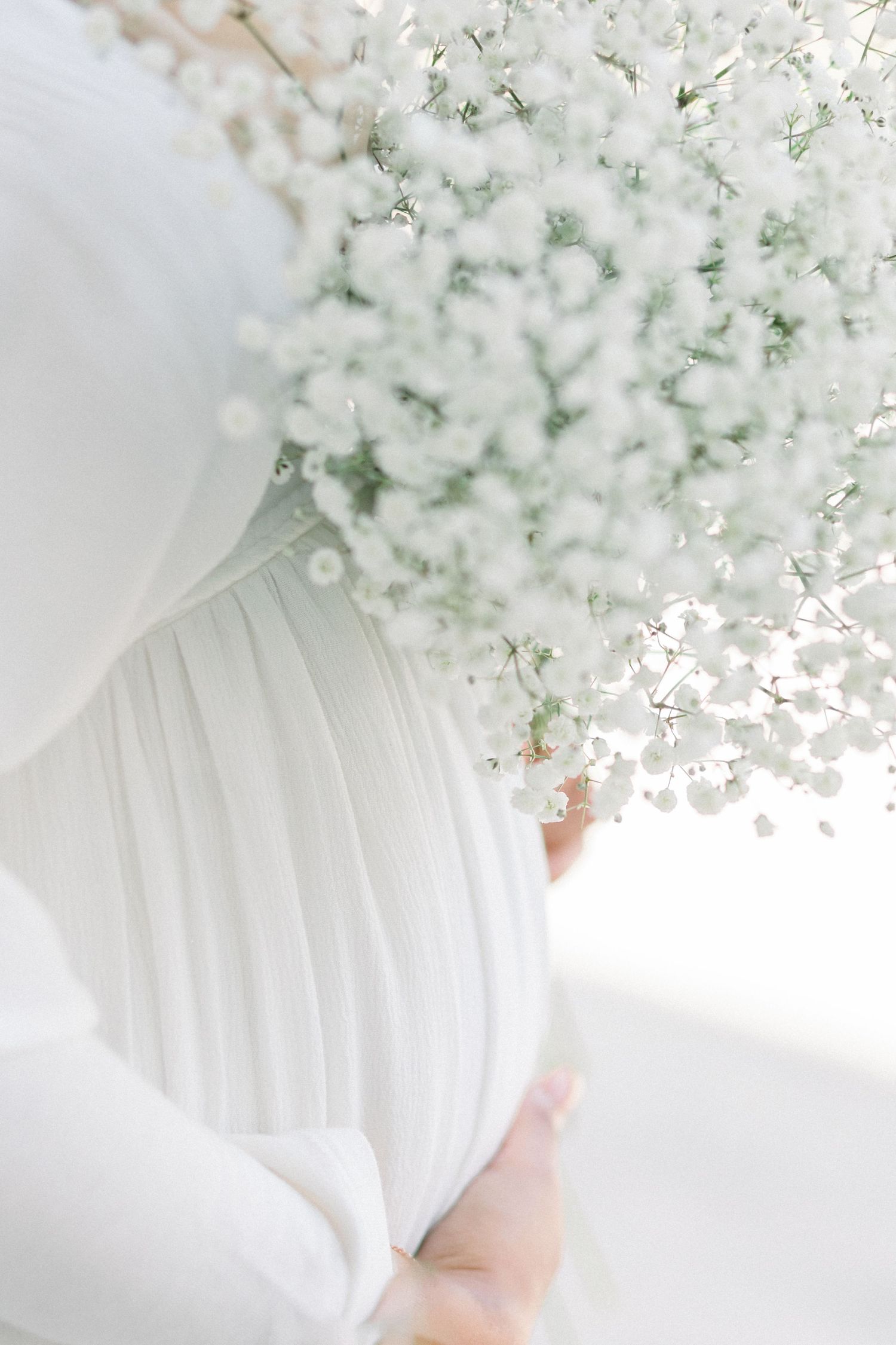 Delicate white baby's breath flowers arranged in a soft, dreamy composition against a light background.