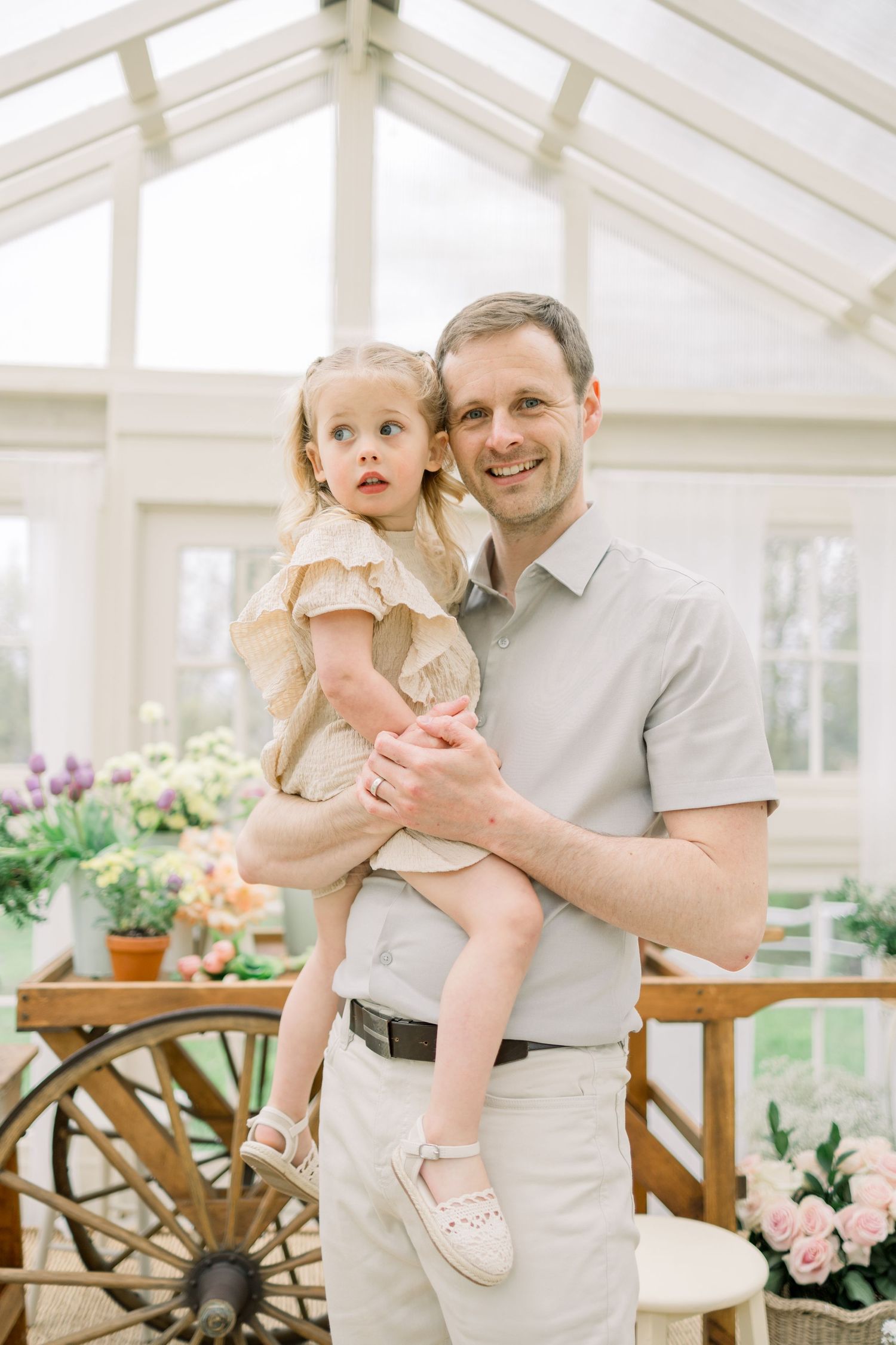 A series of three photos showing a tender moment between parent and child in a bright sunlit conservatory.
