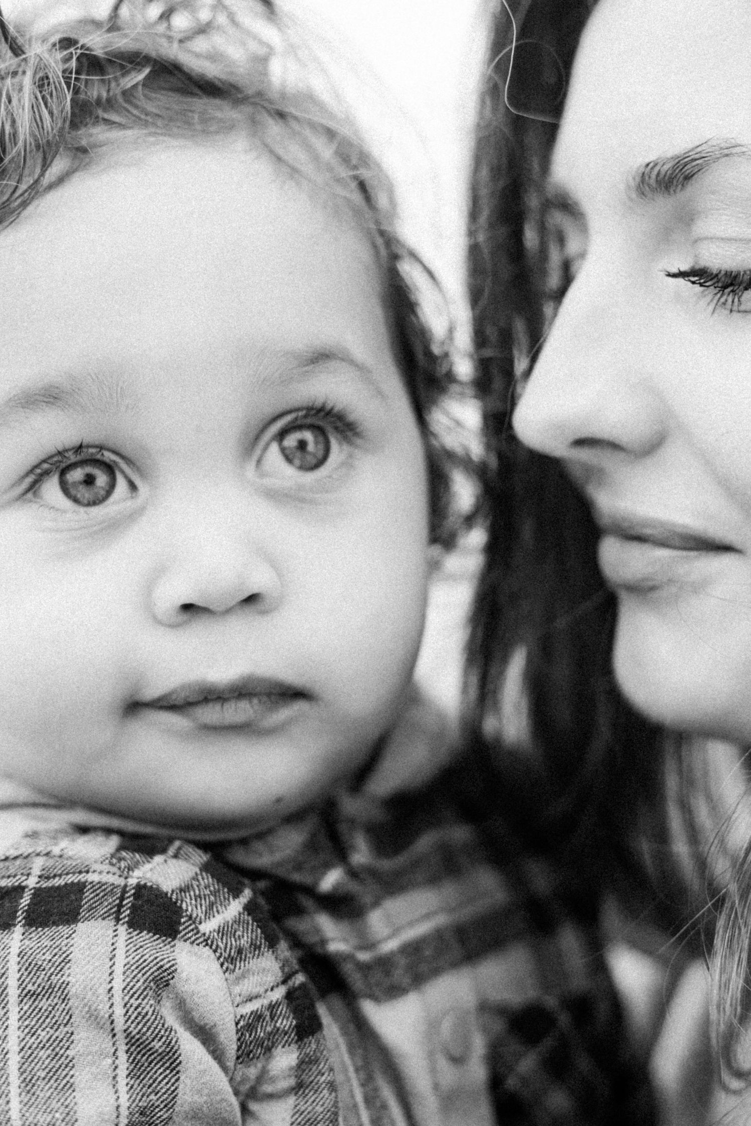 A tender black and white series of close-up shots showing affectionate moments between parent and child.