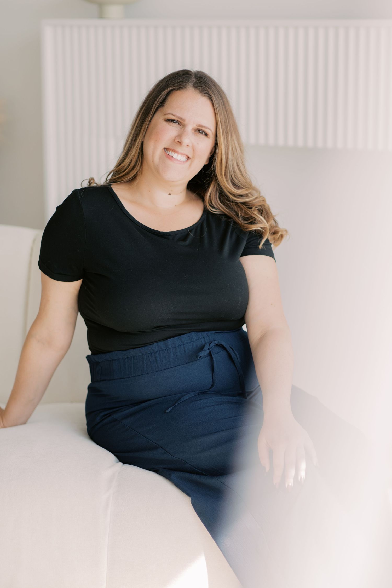 A series of minimalist portraits against a white background showing someone in a black top and navy dress.
