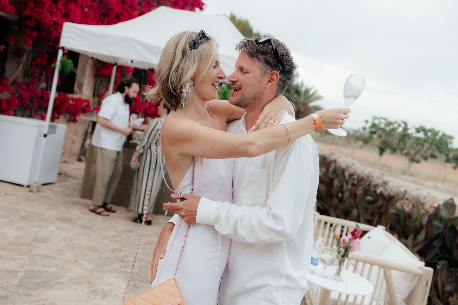 A couple sharing a romantic dance moment at an outdoor celebration.