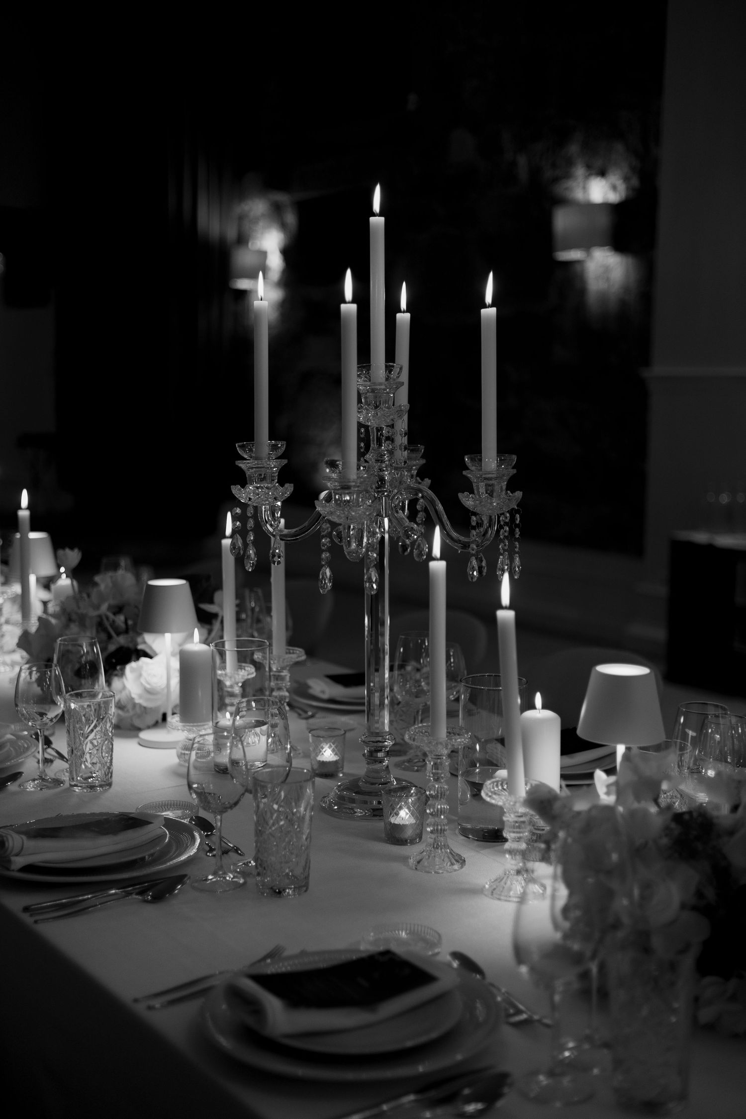 Candlelit wedding dinner in black and white. Romantic, intimate setting with crystal candelabras.