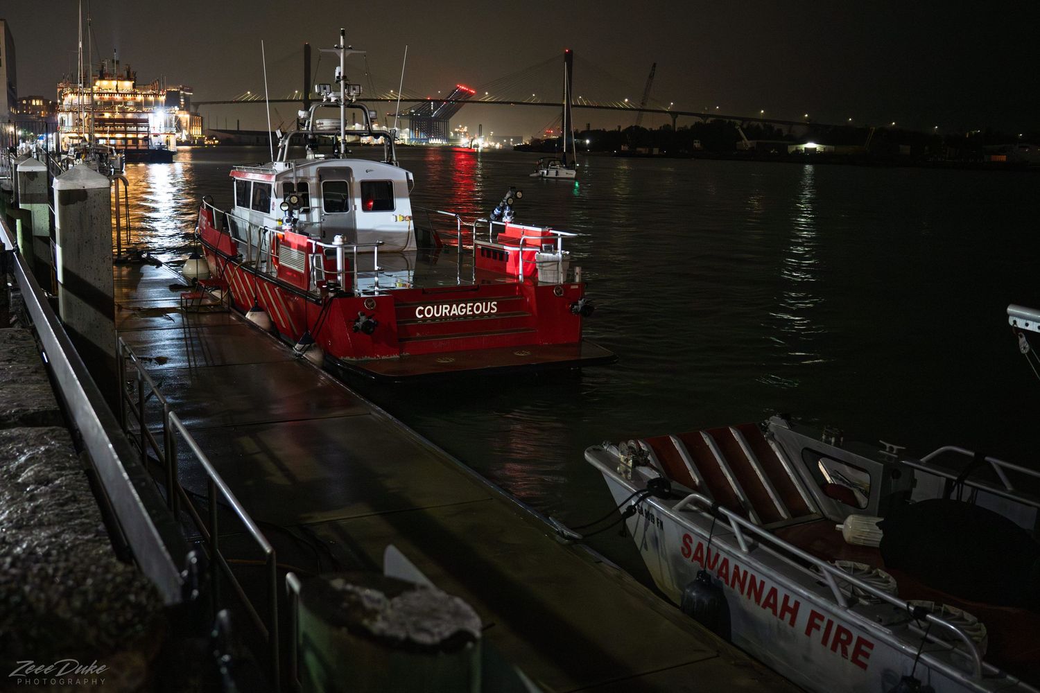Savannah fireboats docked along the harbor at night.