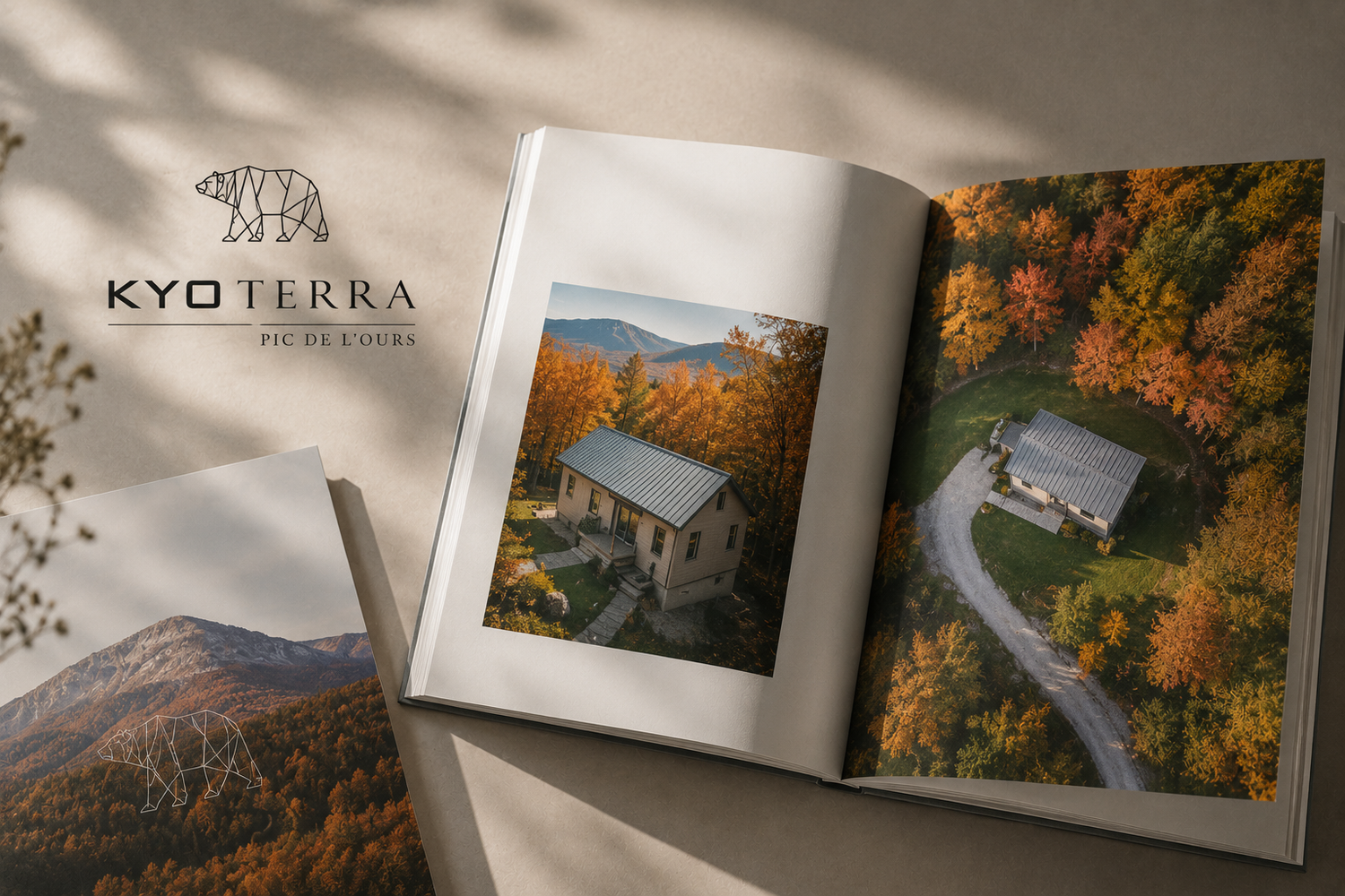 Open magazine book showing aerial autumn forest view with Kyo Terra logo cabin property photography.