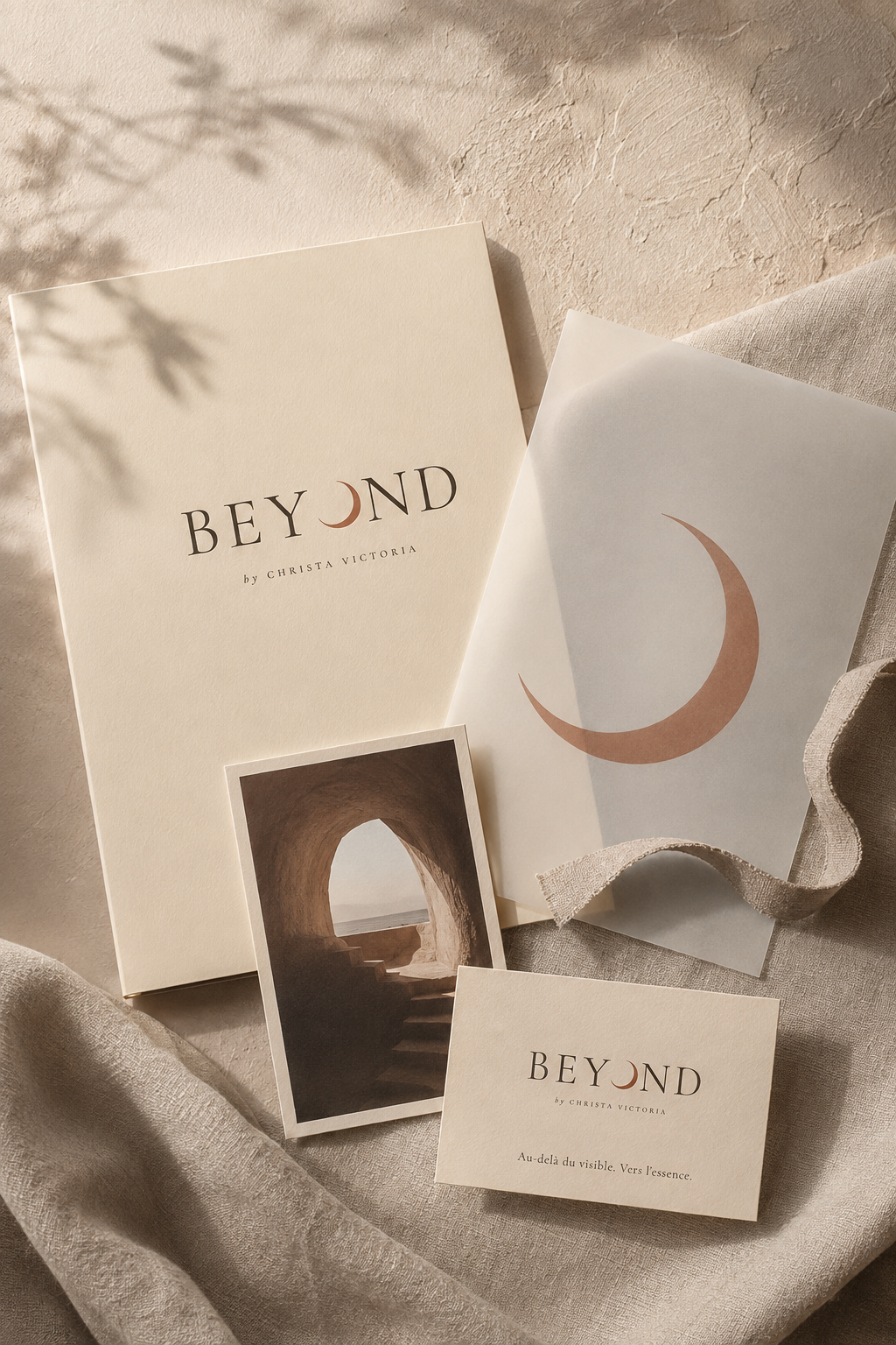 Beyond by Chelsea Victoria brand stationery flatlay with moon logo on beige linen.