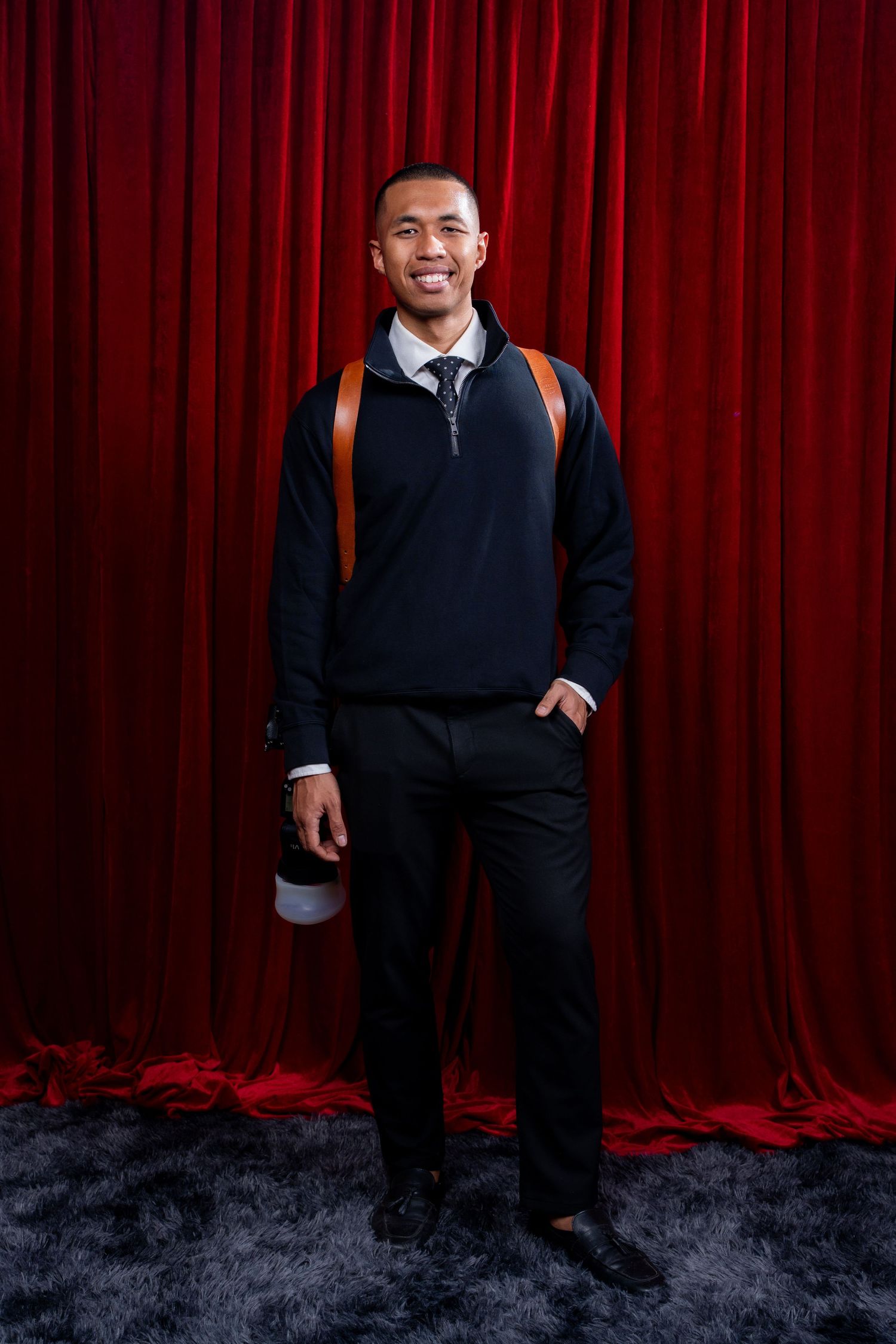 Portrait in front of red curtains at a Melbourne gala ball
