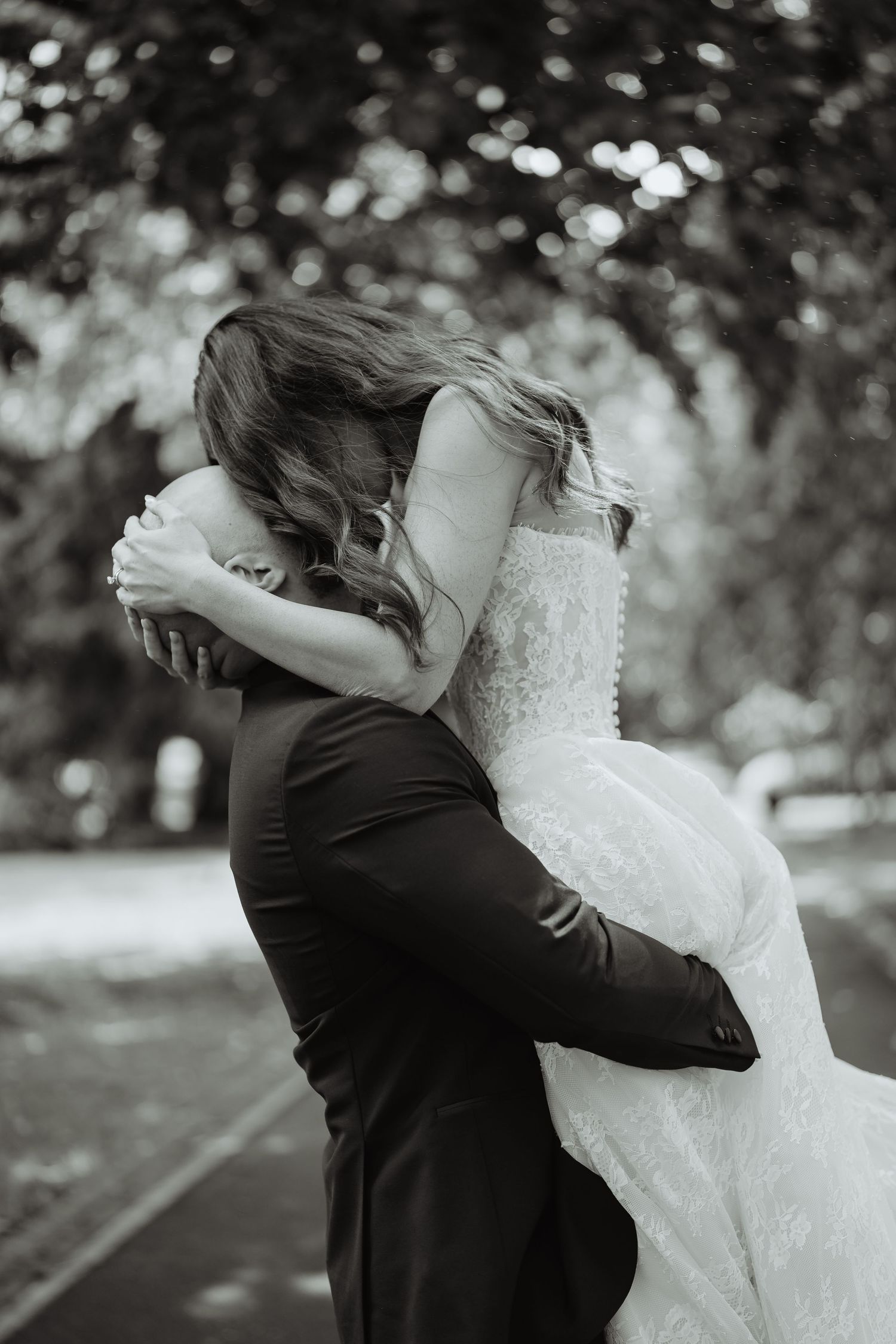 Groom lifting the bride in a black and white wedding photograph