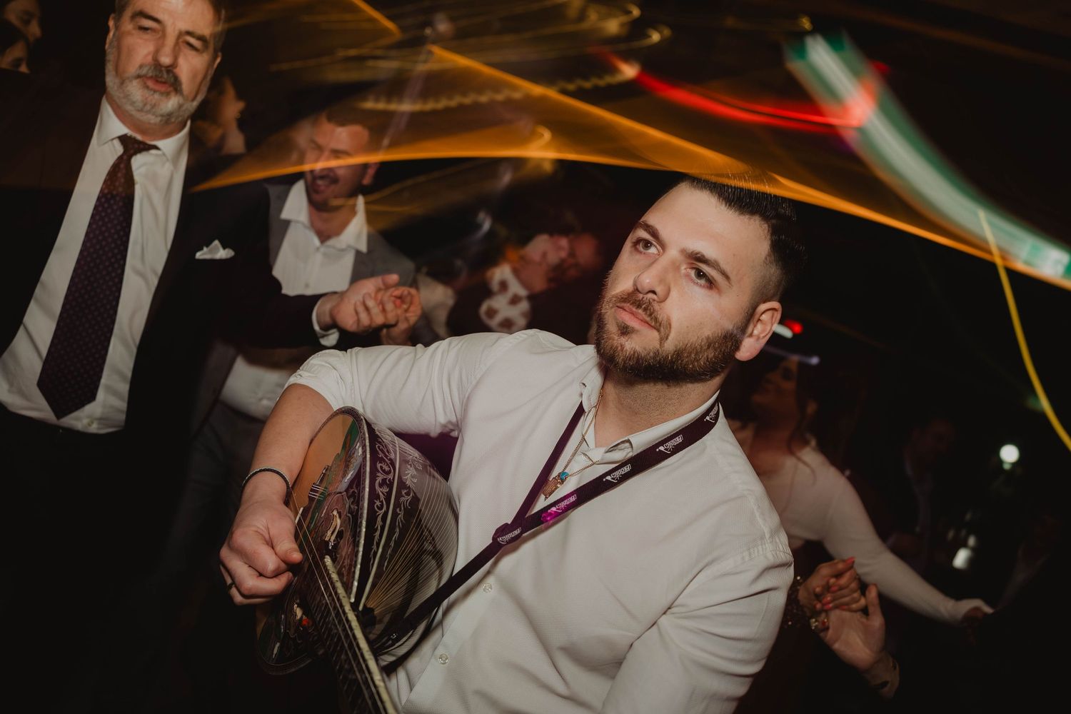 Guest dancing under light trails at a Melbourne wedding reception