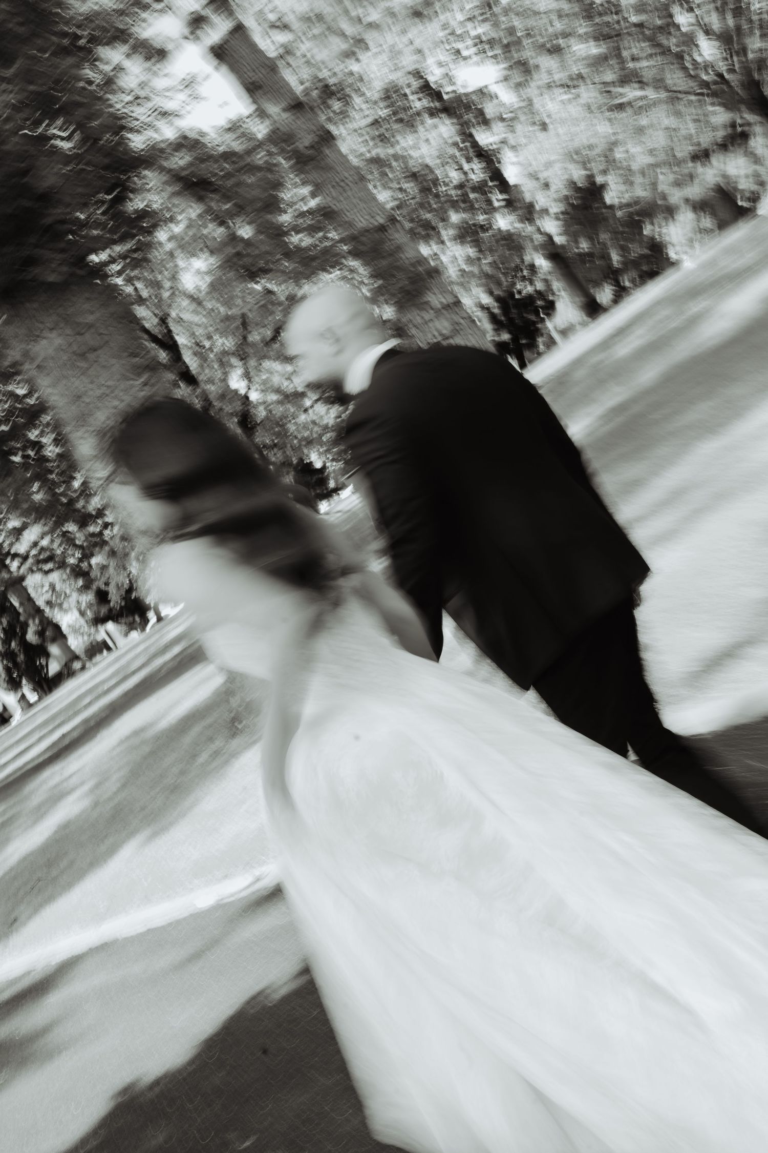Bride and groom in motion, black and white wedding photograph