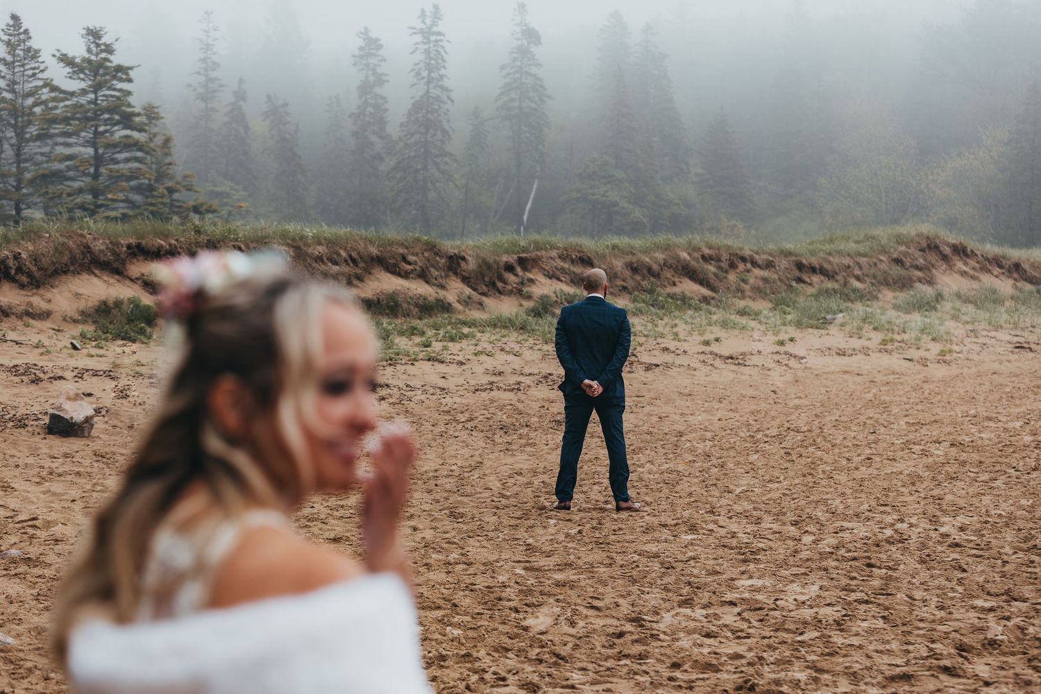 Foggy mountainside ceremony setup with evergreen trees creating a mystical backdrop.