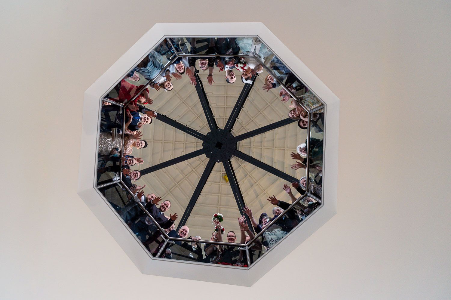 View looking up at an octagonal skylight with ornate architectural details around its perimeter.