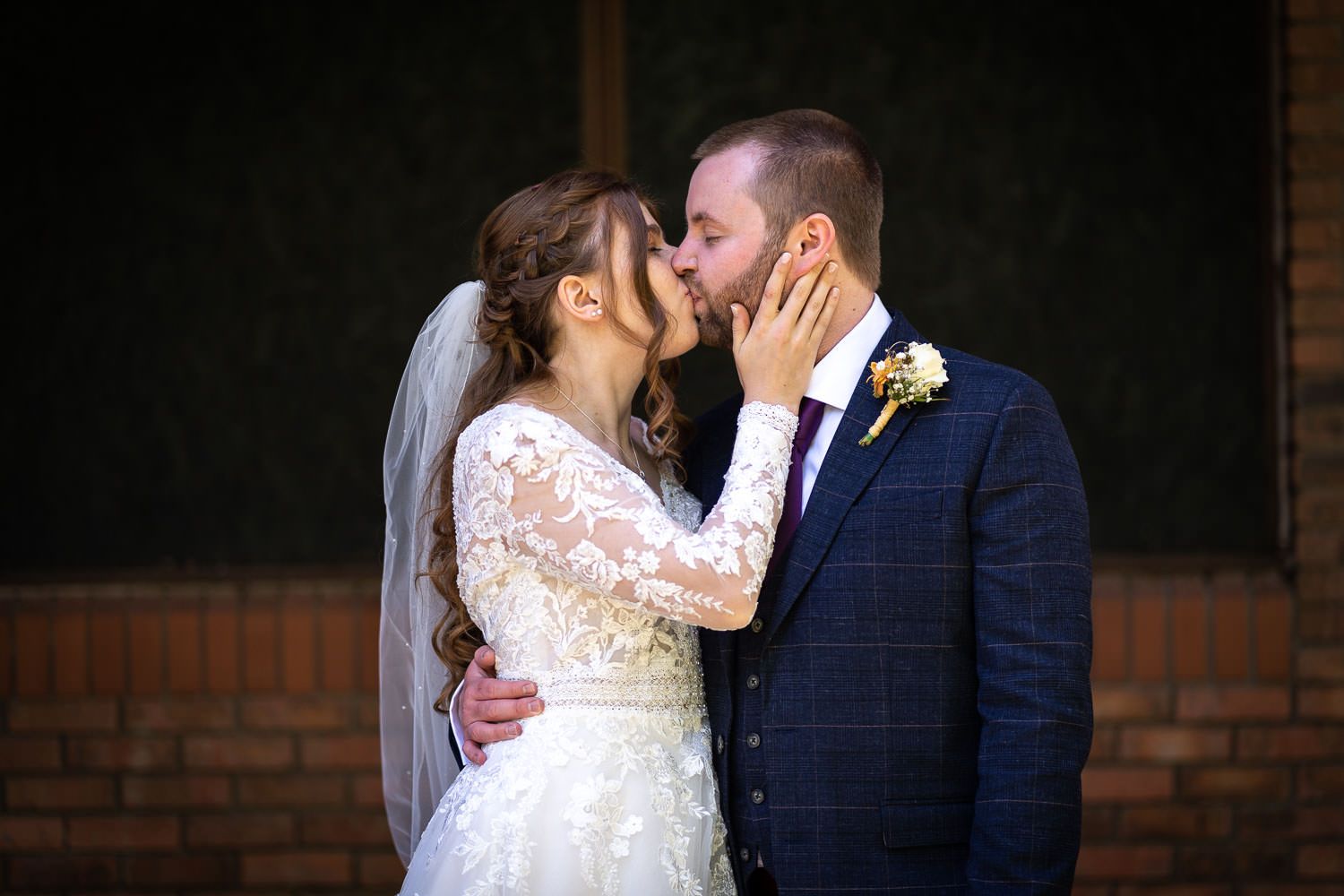 A romantic bride and groom share an intimate moment on their wedding day.