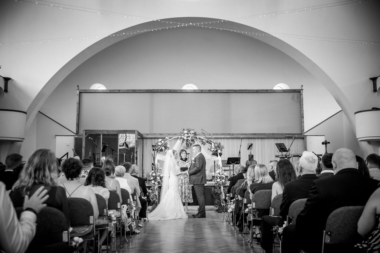 Black and white panoramic collage showing a traditional church wedding ceremony with people seated in pews.