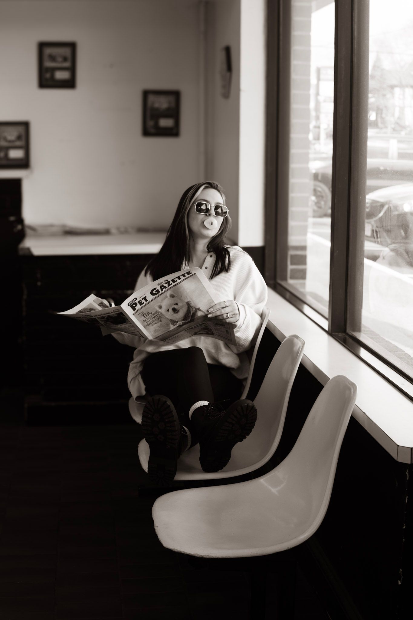A black and white photo sequence shows someone lounging in a chair by a window while reading a newspaper.