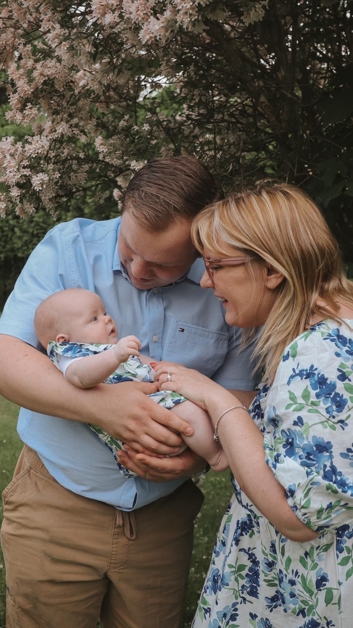 Tender moments captured under flowering trees in springtime.