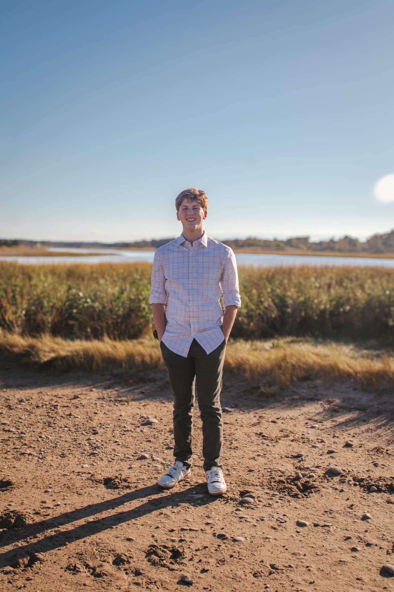 Series of artistic portraits taken in sandy terrain against blue sky.