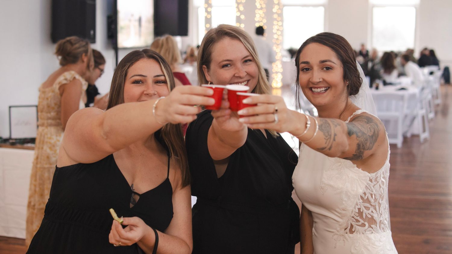Wedding celebration with guests in an industrial-style venue.