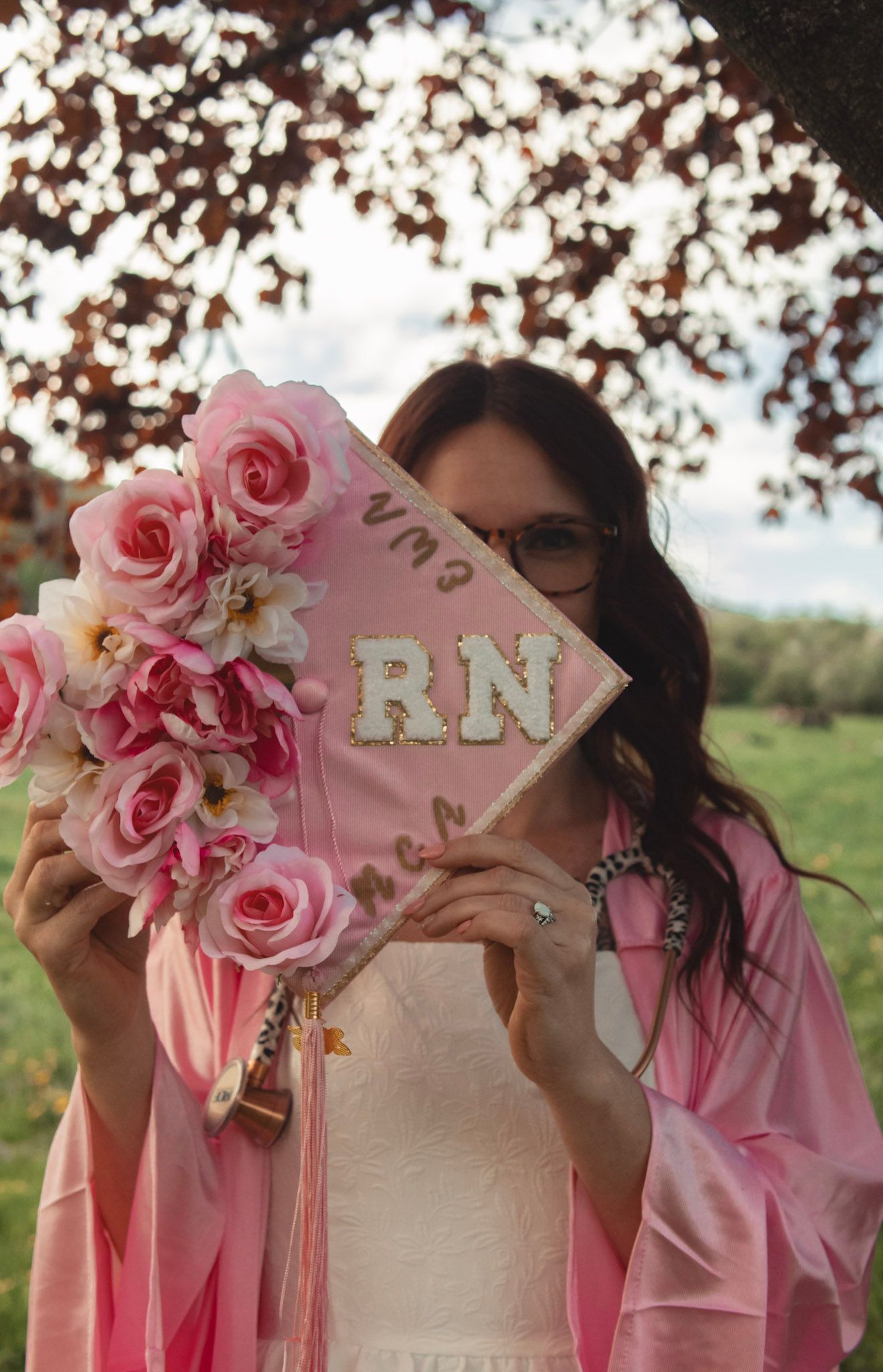 Pink roses and decorative elements arranged on white surface.