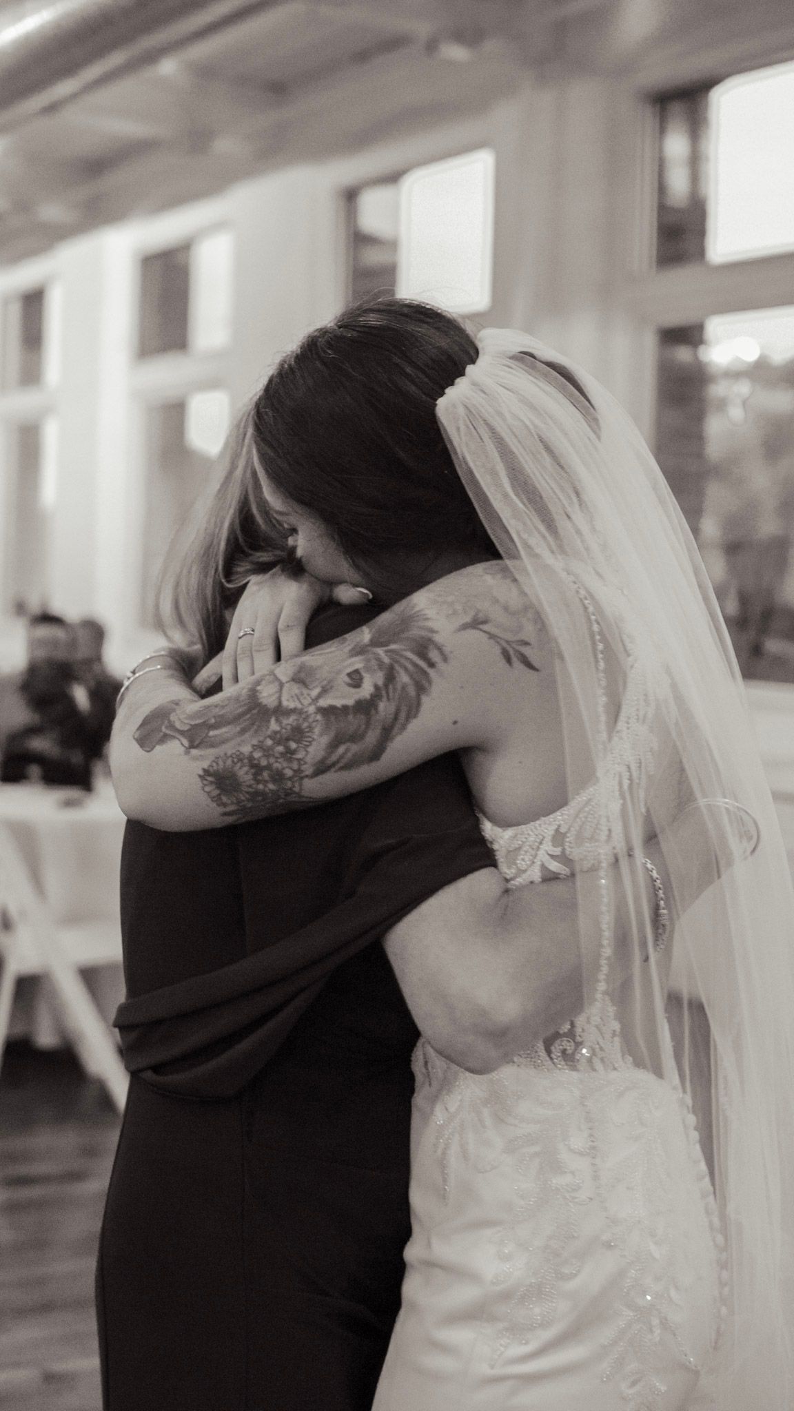 A series of black and white photos showing a couple embracing at a wedding, with the bride in a white dress and veil.