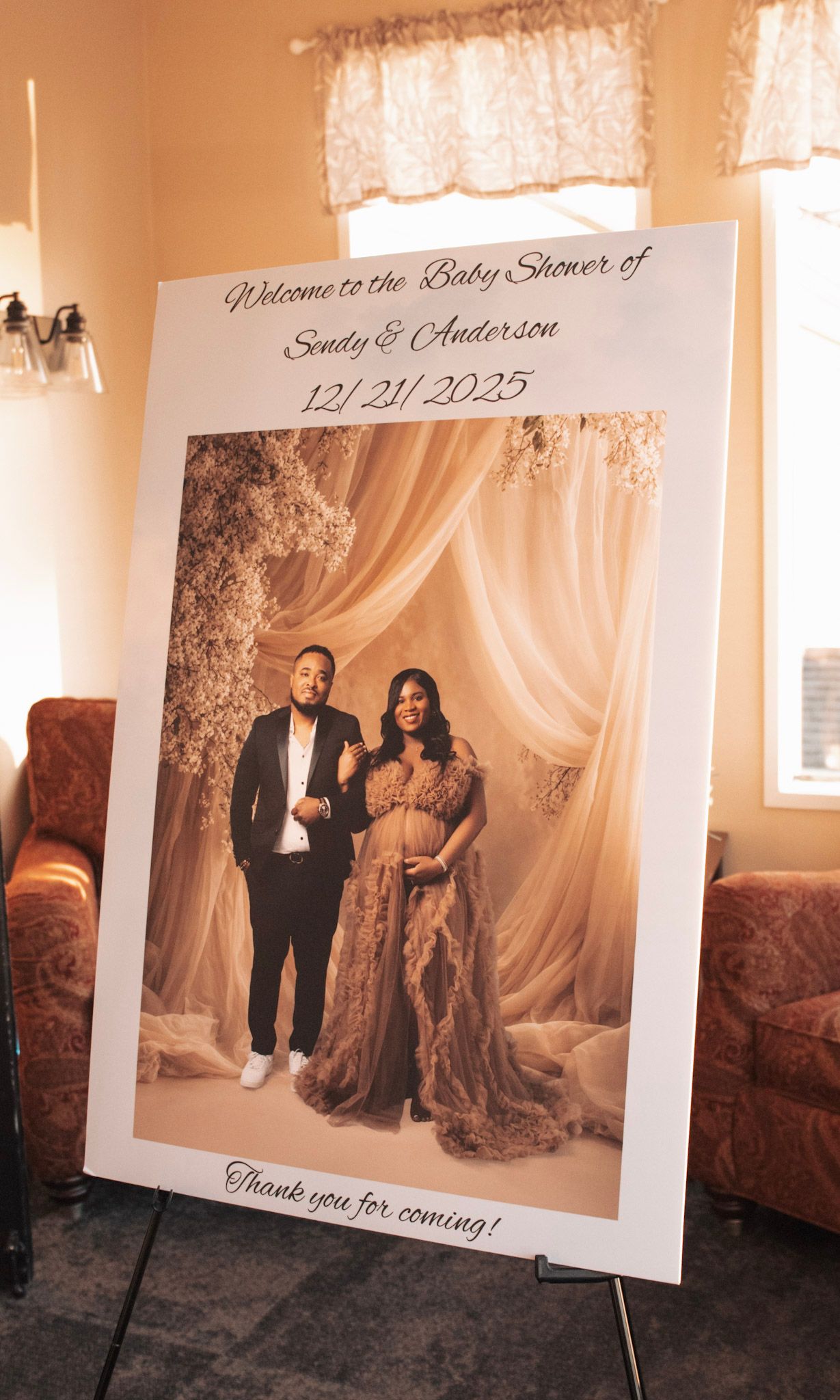 Professional photo display setup with large portrait frames and elegant draping.