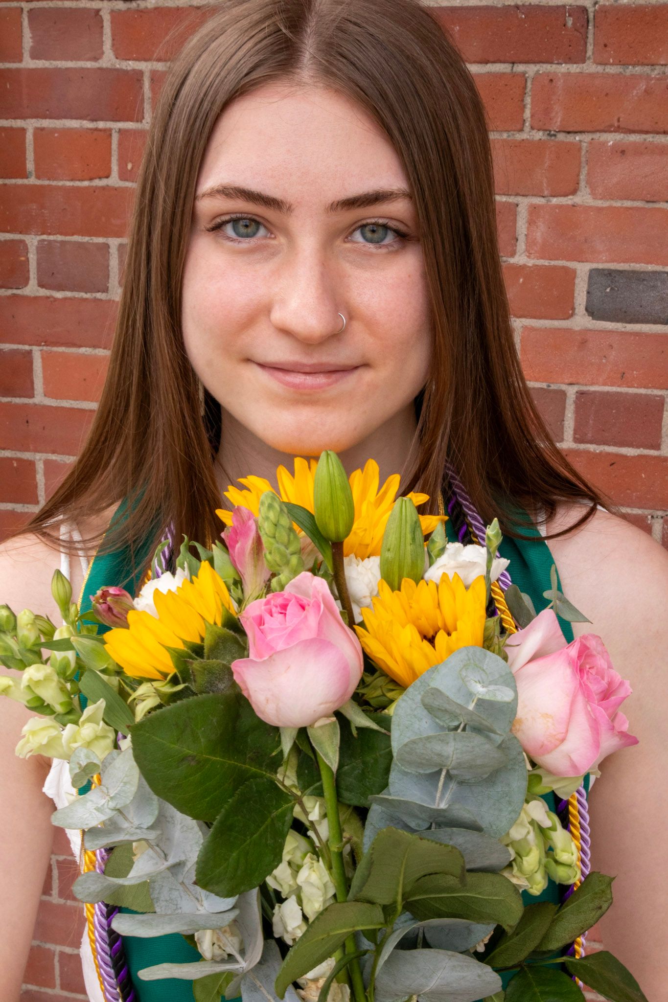 A series of cropped photos showing someone holding a colorful bouquet of sunflowers and pink roses against a brick wall.