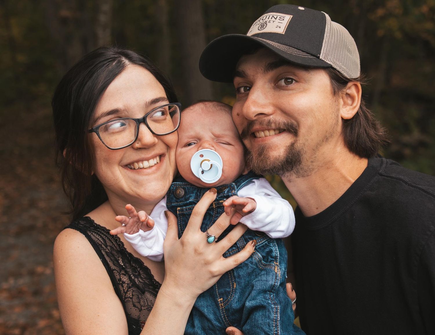 Family sharing tender moments together during an outdoor photo session.