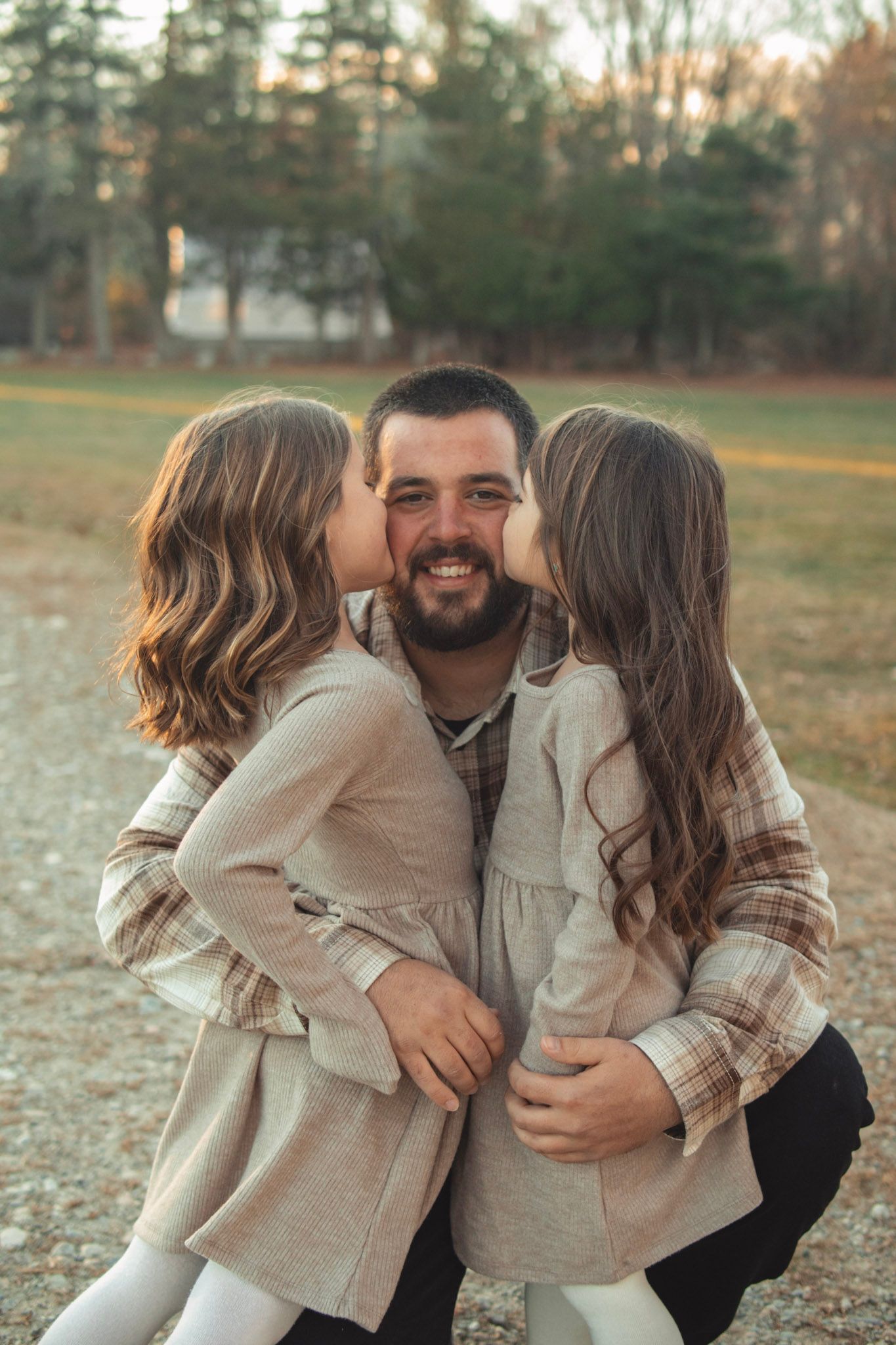 A heartwarming sequence of family embraces and kisses captured during a fall outdoor photo session.