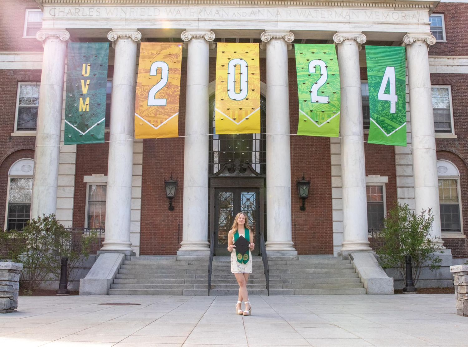 Historic building facade with colorful numbered banners hanging between columns.