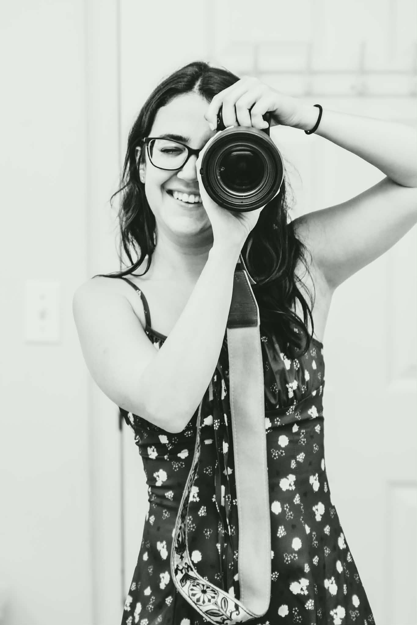 Black and white series of a photographer demonstrating how to use a camera.