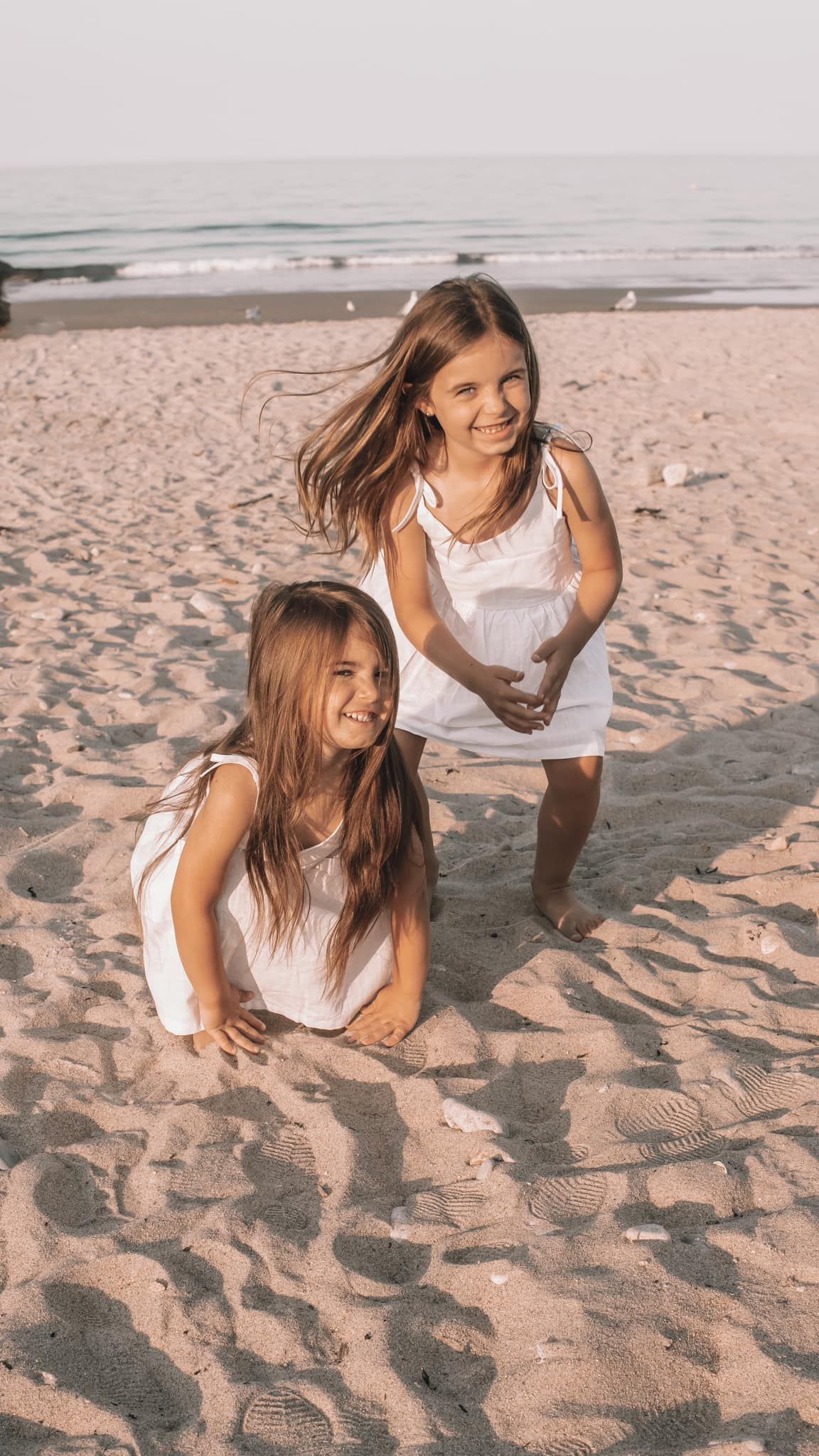 Candid moments of joy and laughter on a sandy beach at sunset.