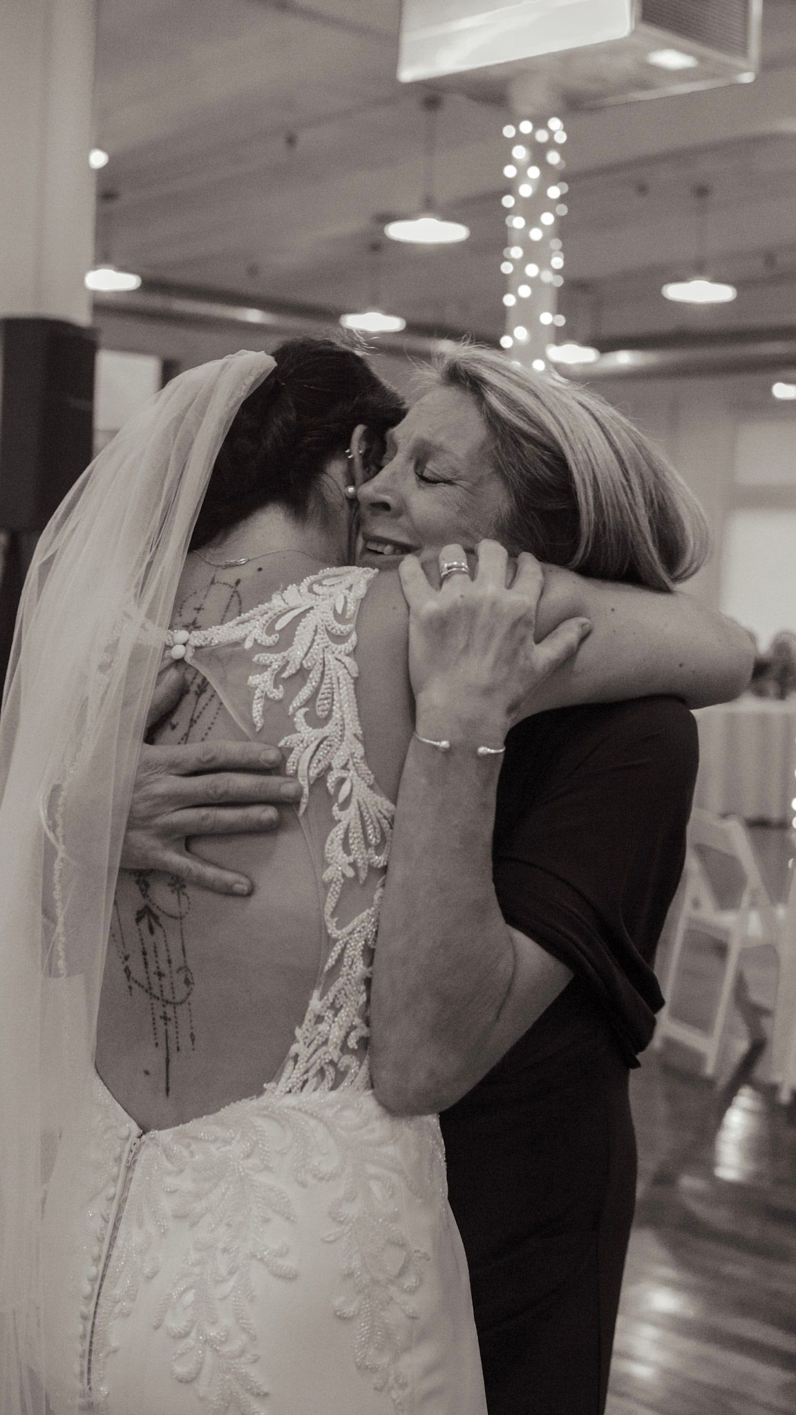 A series of black and white photos showing a romantic dance dip between two people in formal wedding attire.