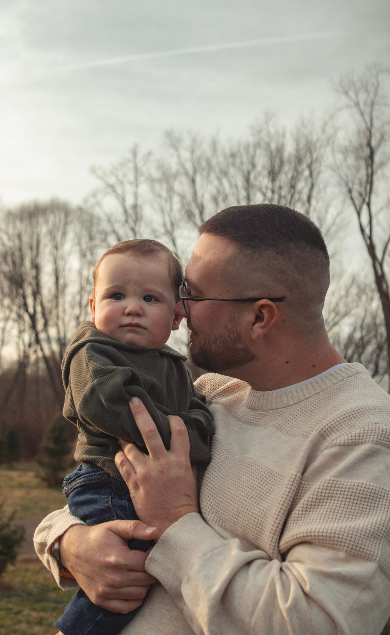 Sweet candid moments captured between two people sharing affectionate interactions outdoors in winter light.