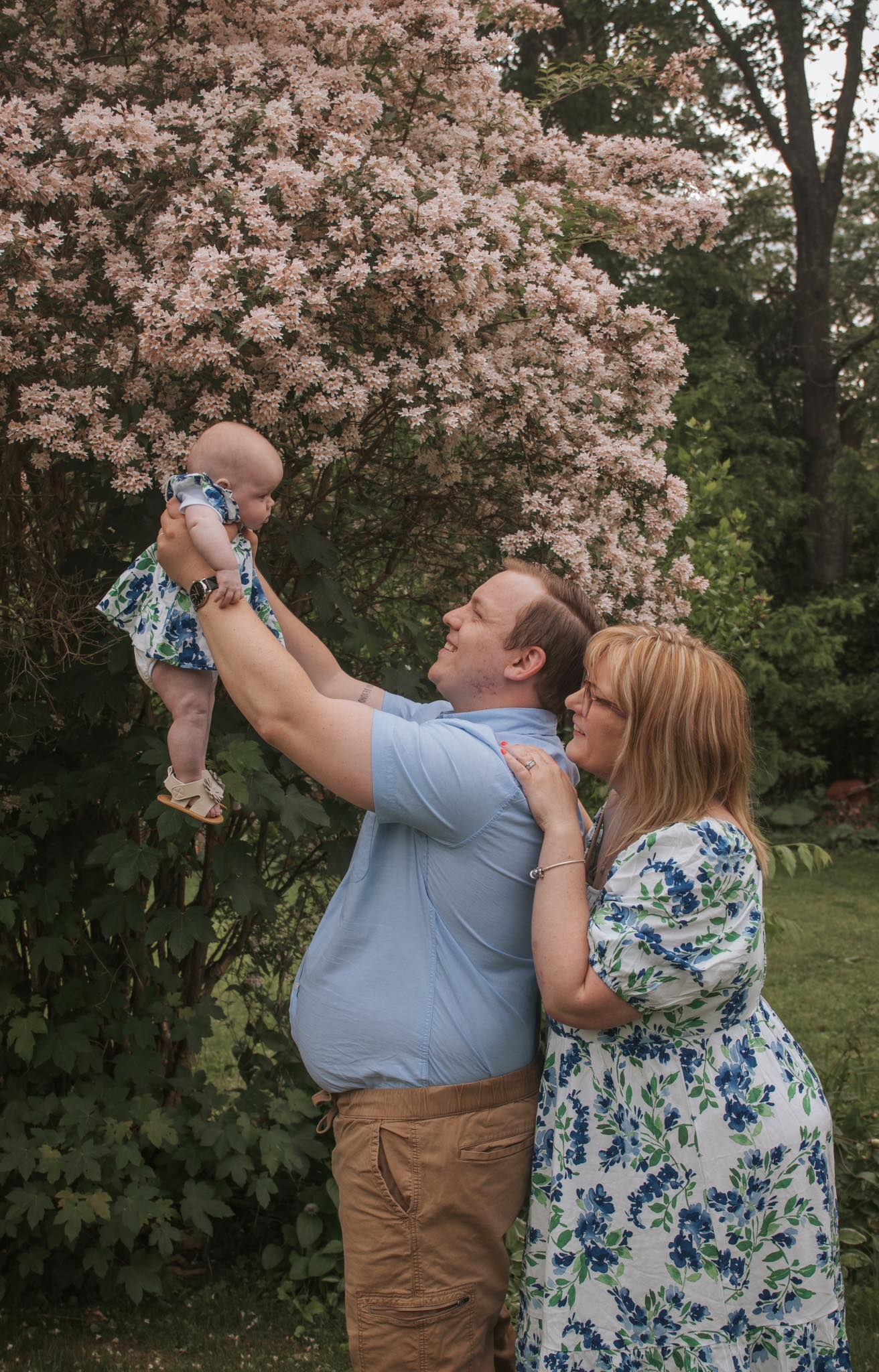Joyful outdoor photo sequence under blooming cherry blossom trees.